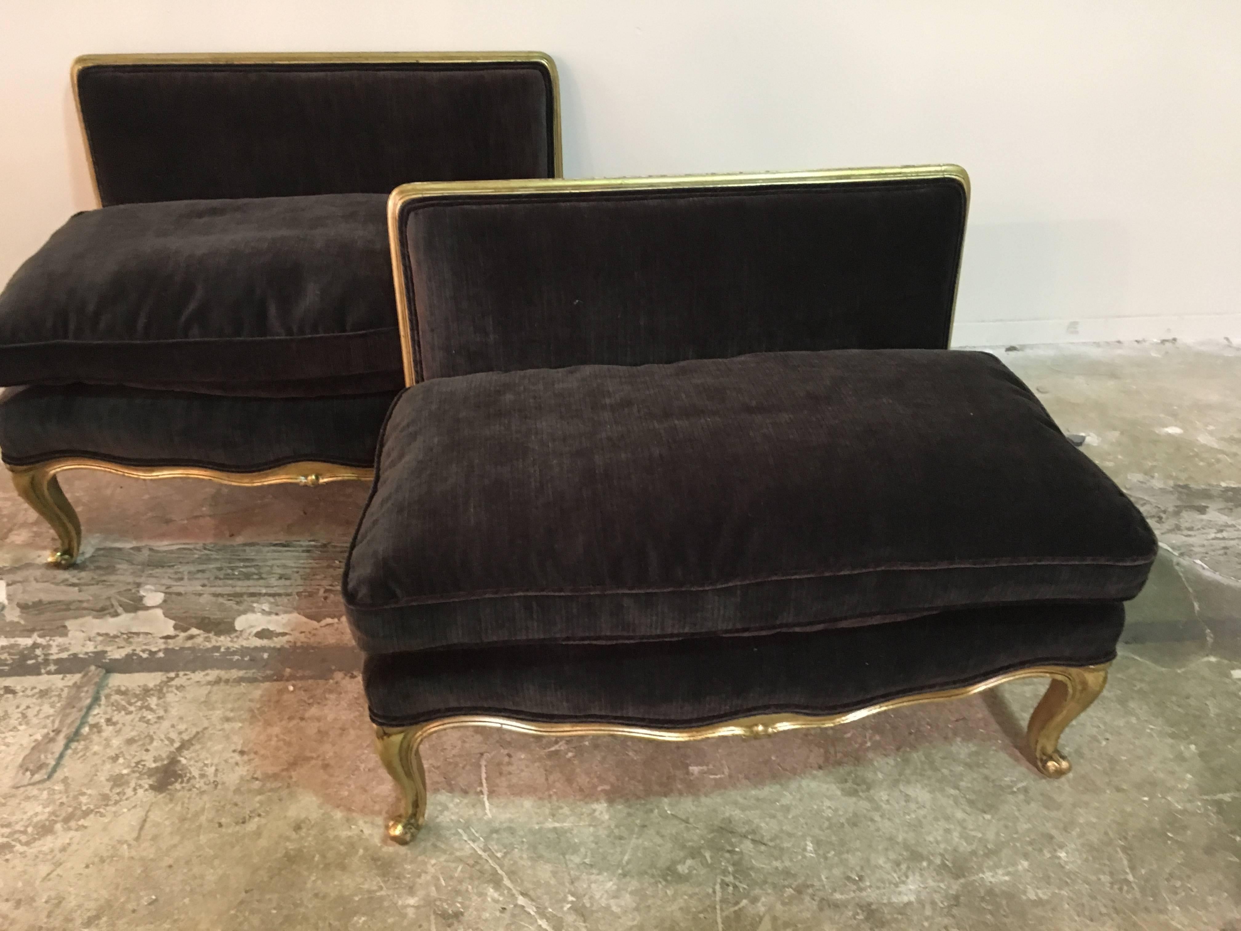 A pair of newly upholstered brown velveteen French settees with gilded wood frames.