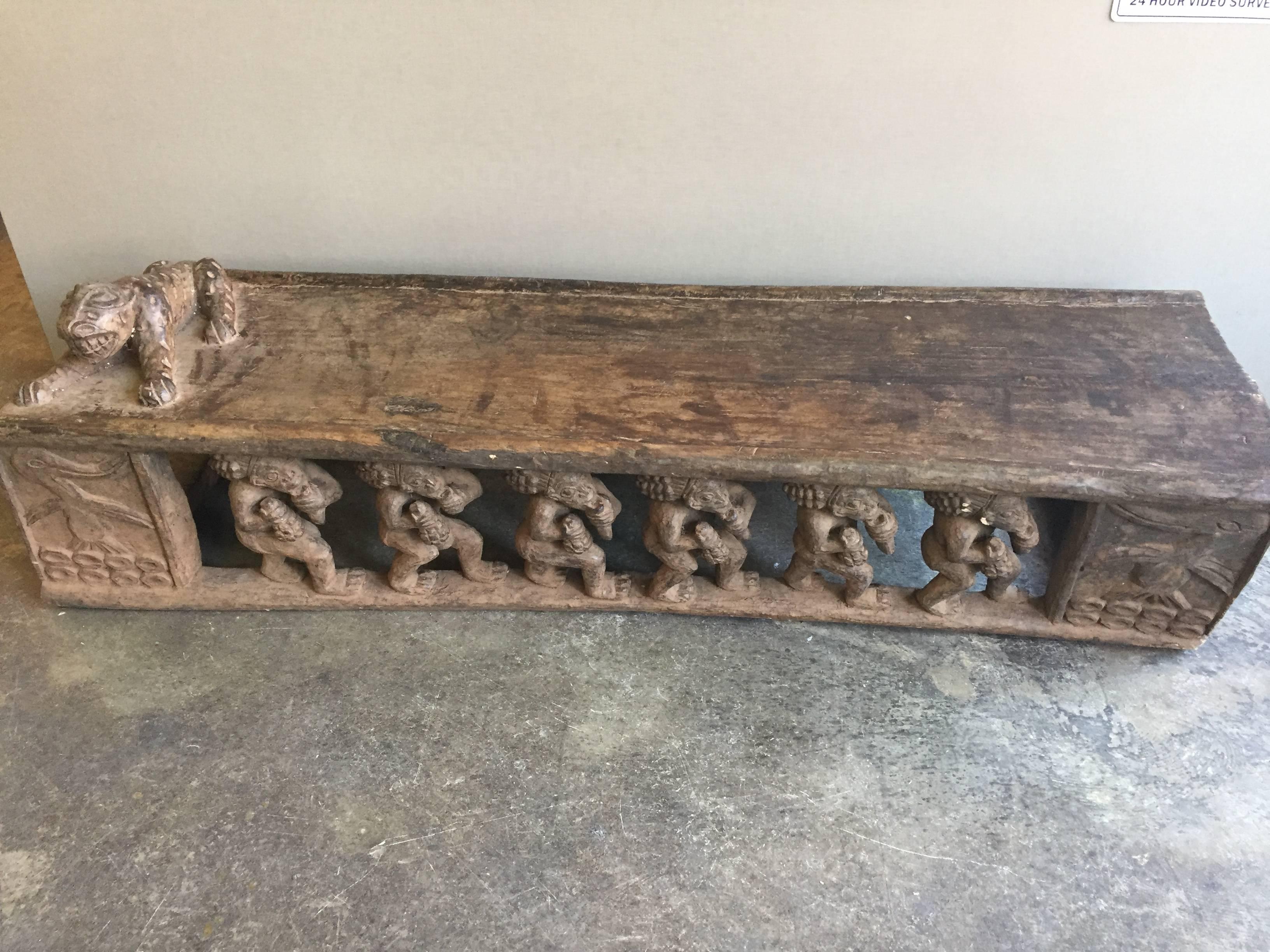 Hand-carved Bamileke bed from Cameroon having a hand carved figural leopard pillow and elaborately carved figures on two sides.