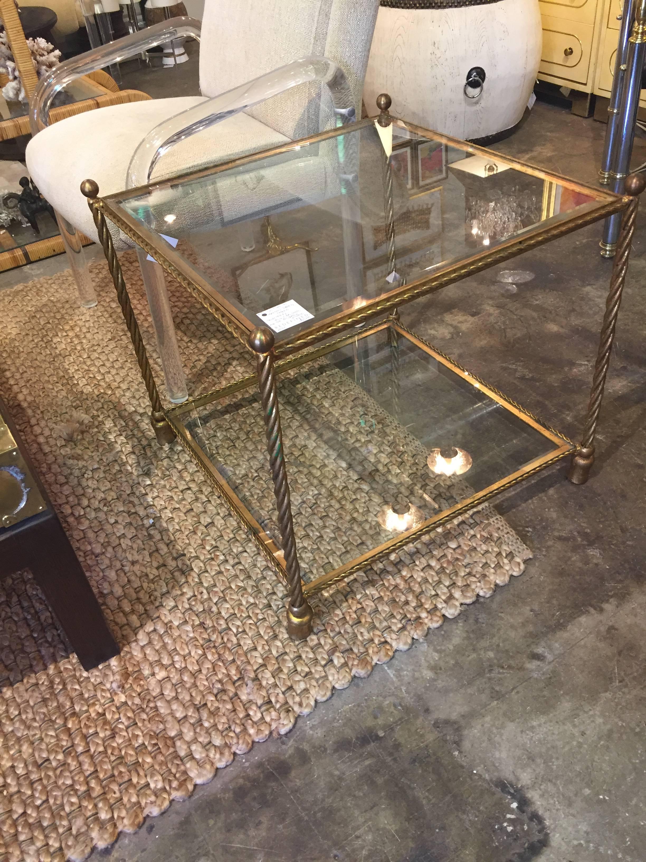Pair of brass two-tiered side tables attributed to Maison Jansen. Decorator Billy Baldwin selected these tables for an important Lake Forest, Illinois estate. The tables have a great scale.
