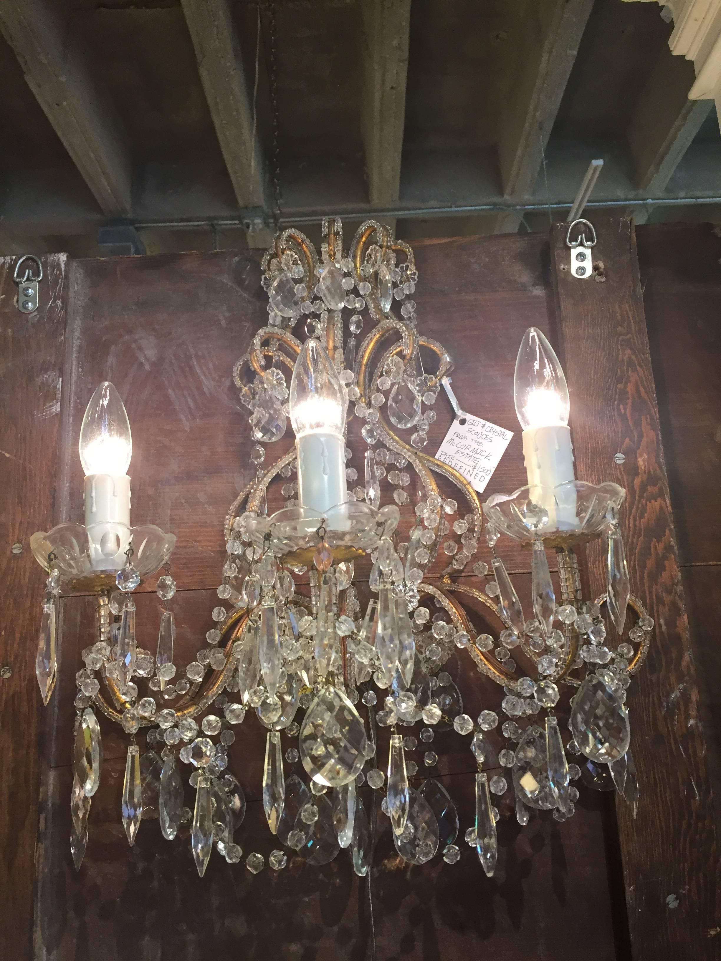 Pair of Mid-Century Italian beaded crystal gilt metal three-light sconces. Decorator Billy Baldwin selected these sconces for an important Lake Forest,
Illinois Estate.