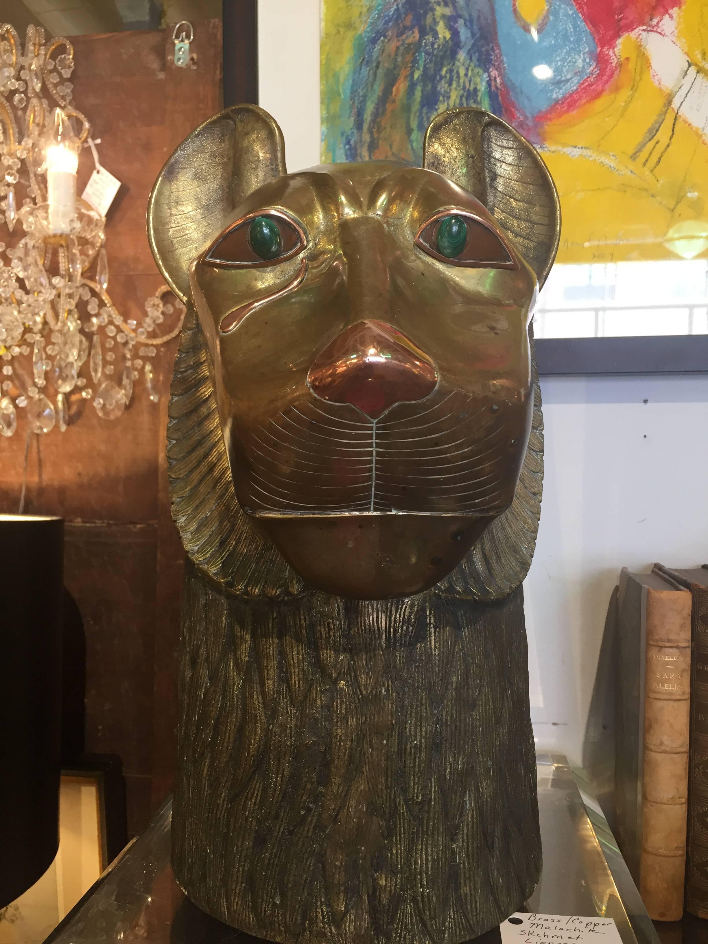 Brass finished metal sculpture of the Egyptian goddess Sekhmet having malachite eyes retailed by famed Interior Designer Richard Himmel in the 1970s.Attributed to Maitland-Smith. Not attached to Lucite base but will include it in the sale of the