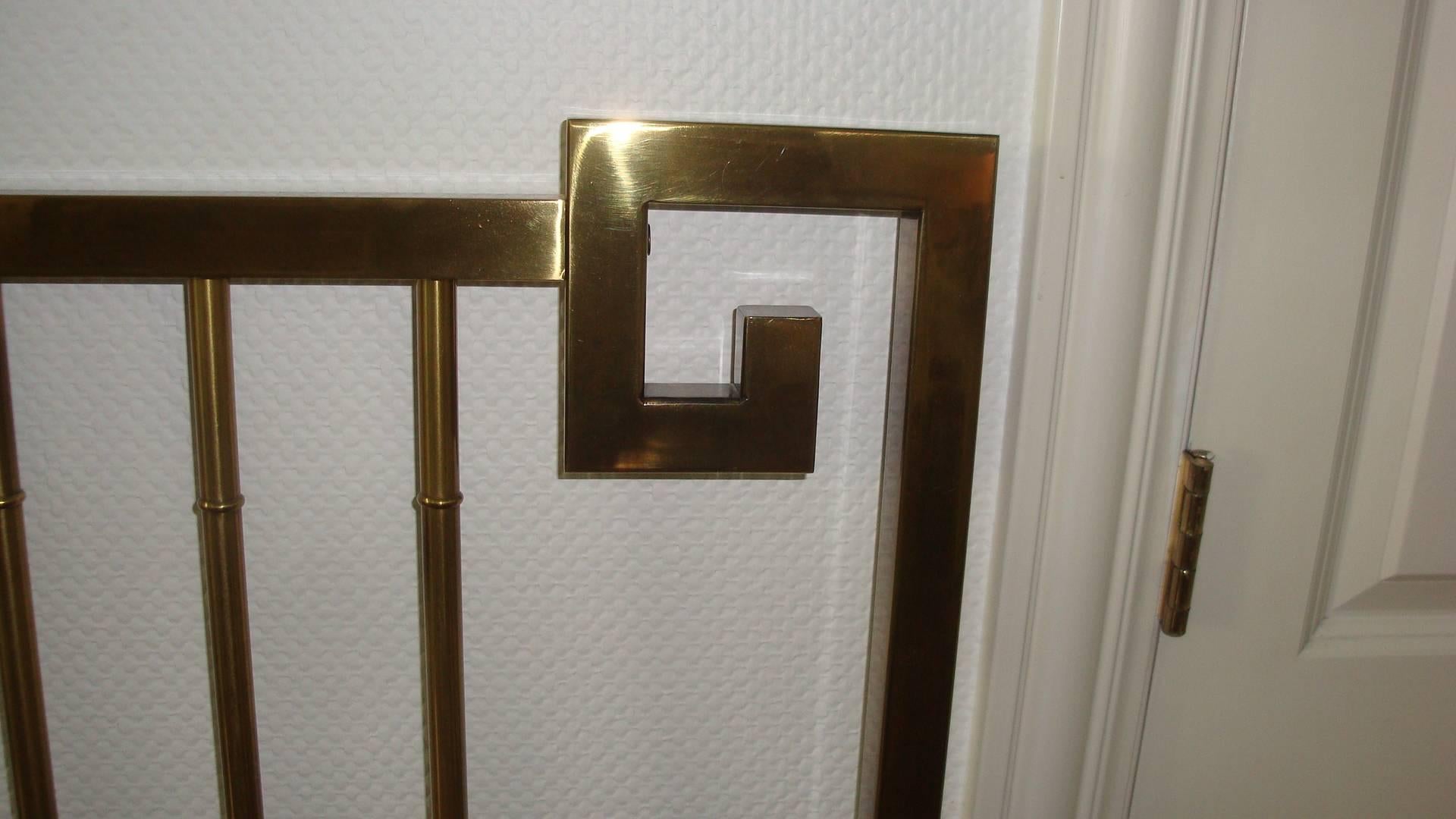 This is a brass queen size Greek key design headboard made by Mastercraft It has Hollywood Regency style.