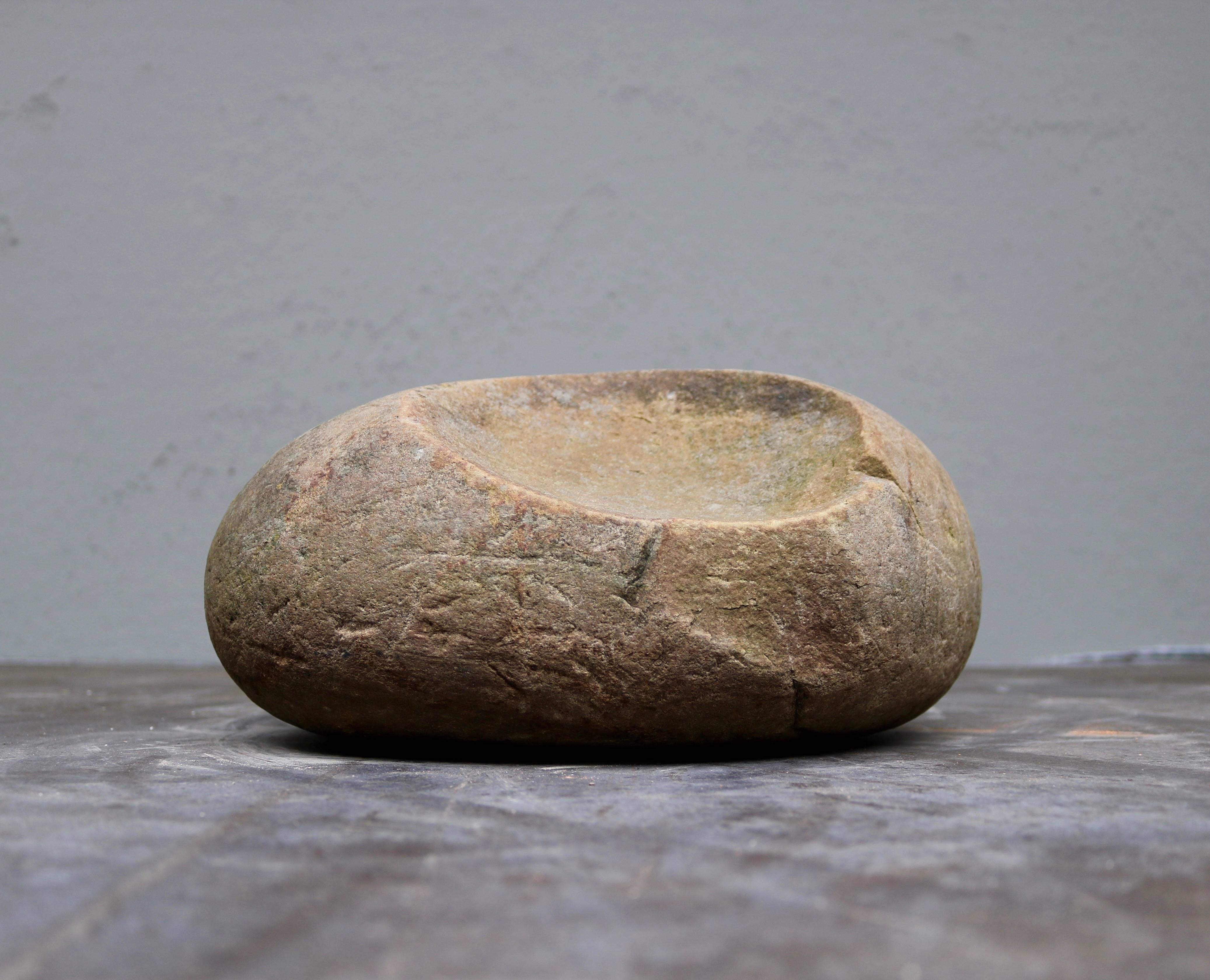 The mortar is made in granite and was used for making flour in the old Danish middle ages.