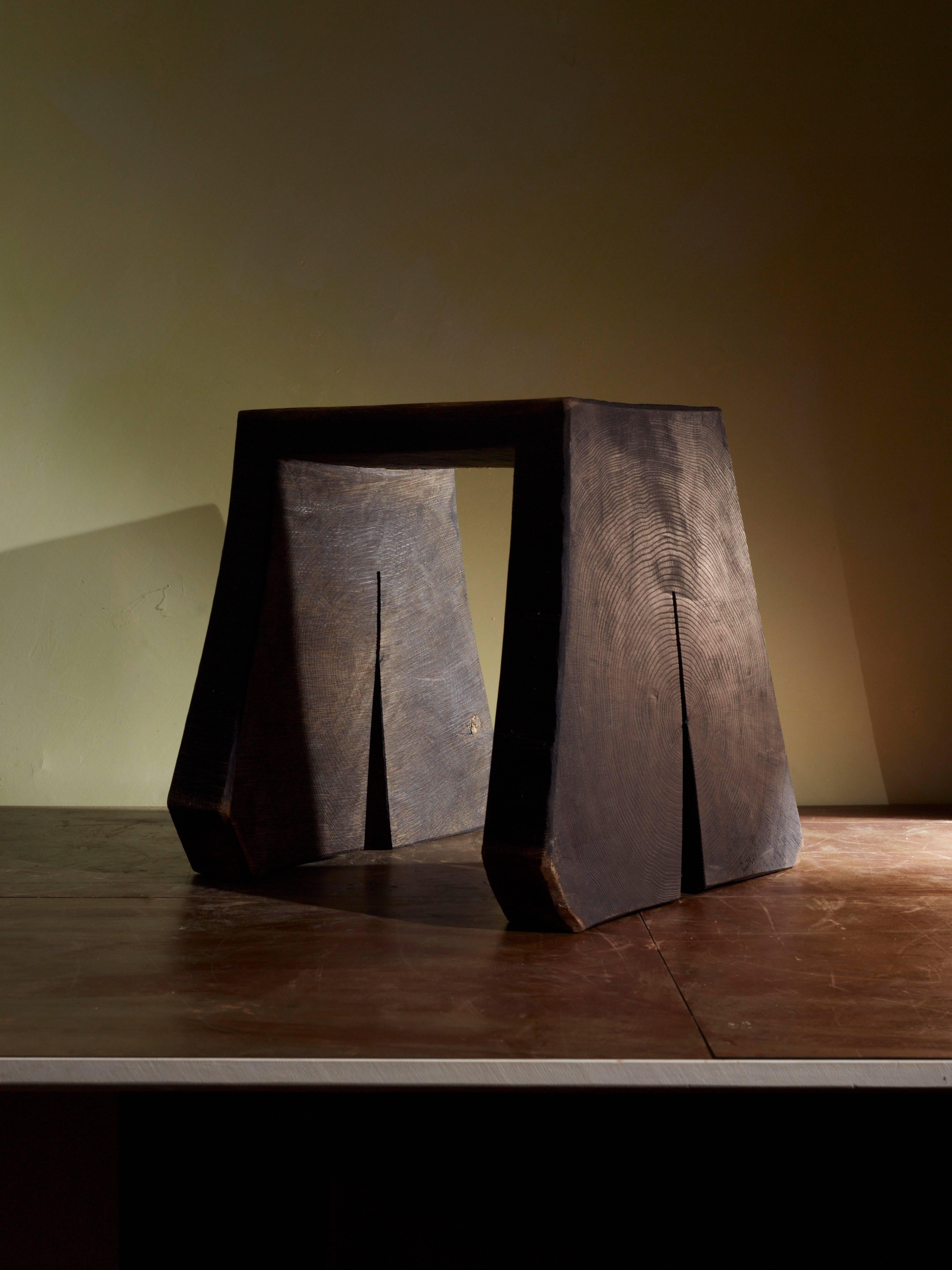 Hocker stool by German artist Fritz Baumann. 
Unique piece. 
Made of one piece of wood - ebonized and oiled oak.
Please note: This item is located in our New York City Studio and will be shipped from there.