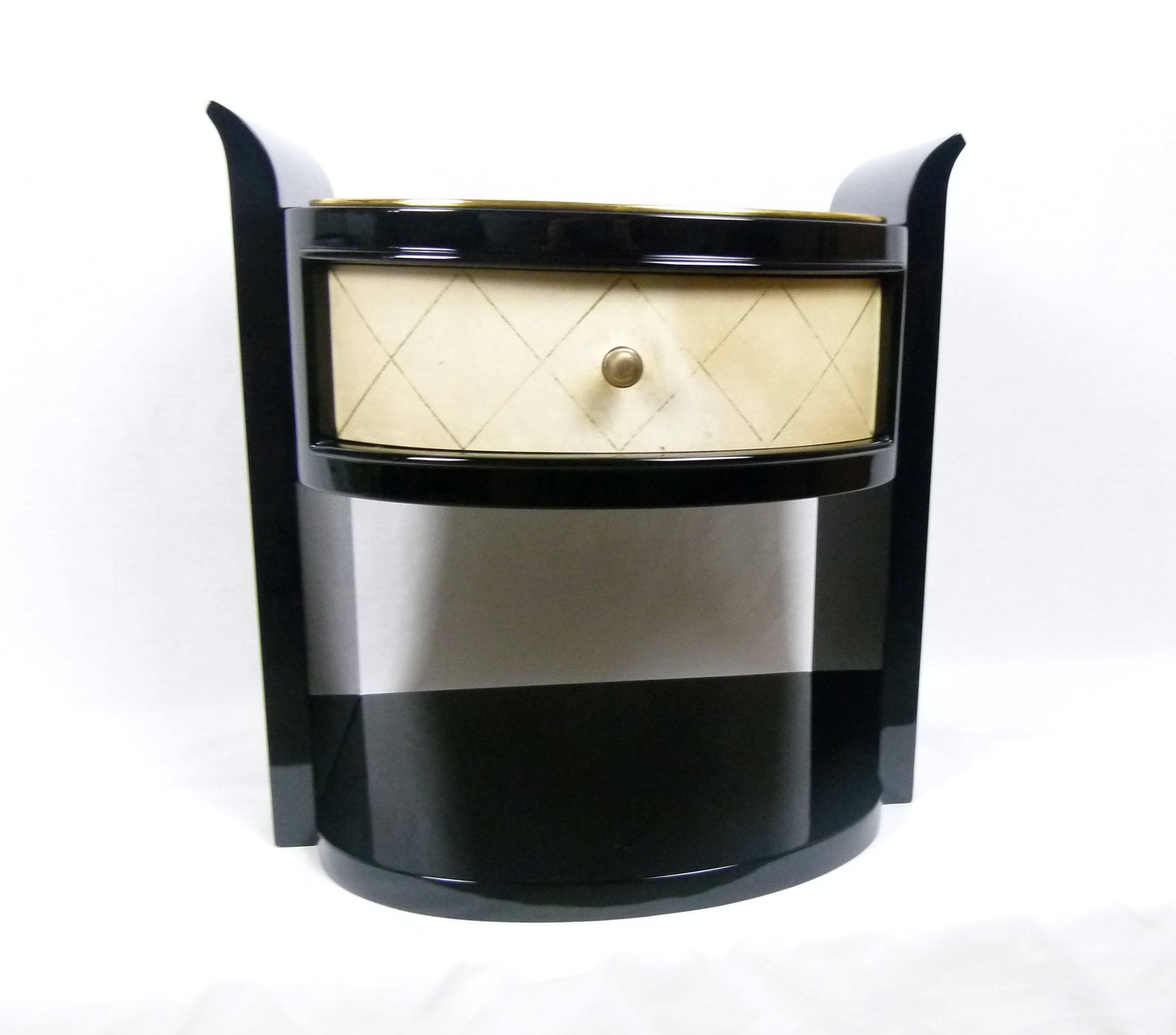 Pair of wall bedside tables in black lacquered wood and parchment.
These bedside tables consist of two black lacquered wood sides connected together by a black lacquer box with a parchment wrapped front drawer.
A black lacquer shelf connects the