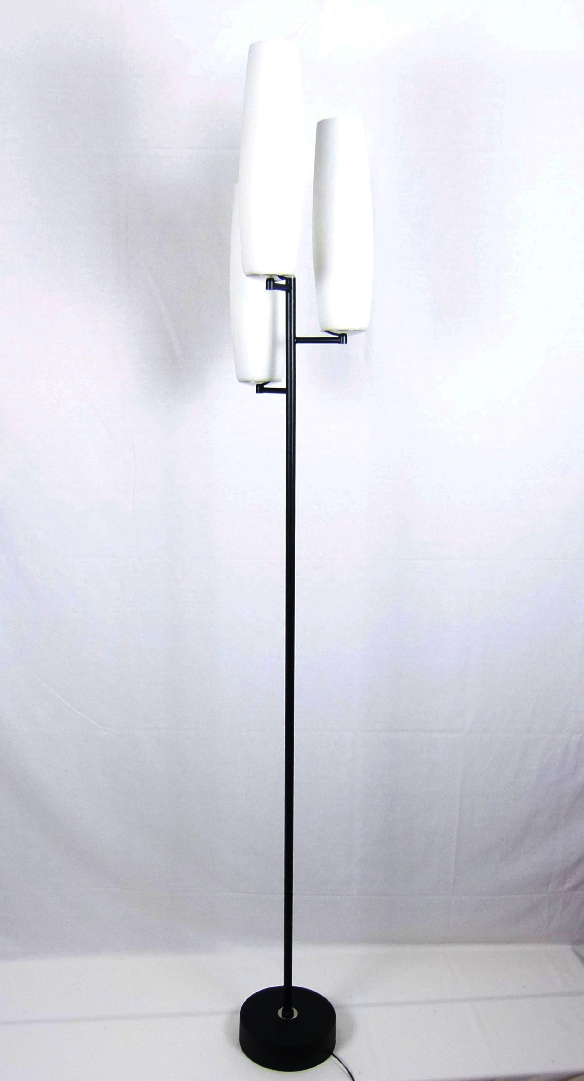 Black lacquered metal and opaline floor lamp consisting of a circular base in black lacquered metal on which is placed a cylindrical lacquered metal trunk supporting three offset opal glass lights.
Each glass is set on a circular nickel metal