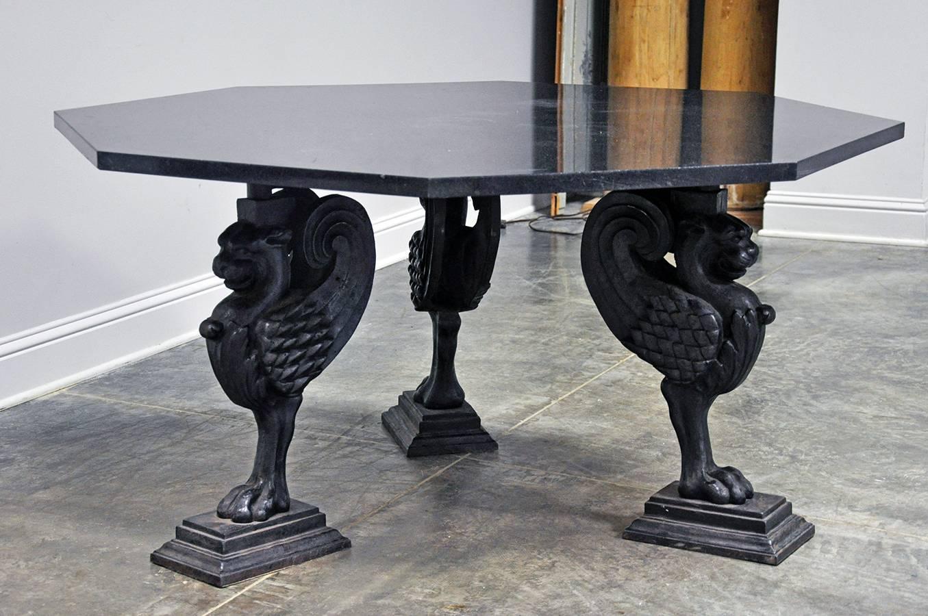 20th century French octagonal table in black granite atop three cast iron griffin legs. Would make for a stunning entry or game table. 

Established in 1979, Joyce Horn Antiques, ltd. continues its 38 year tradition of being a family owned and