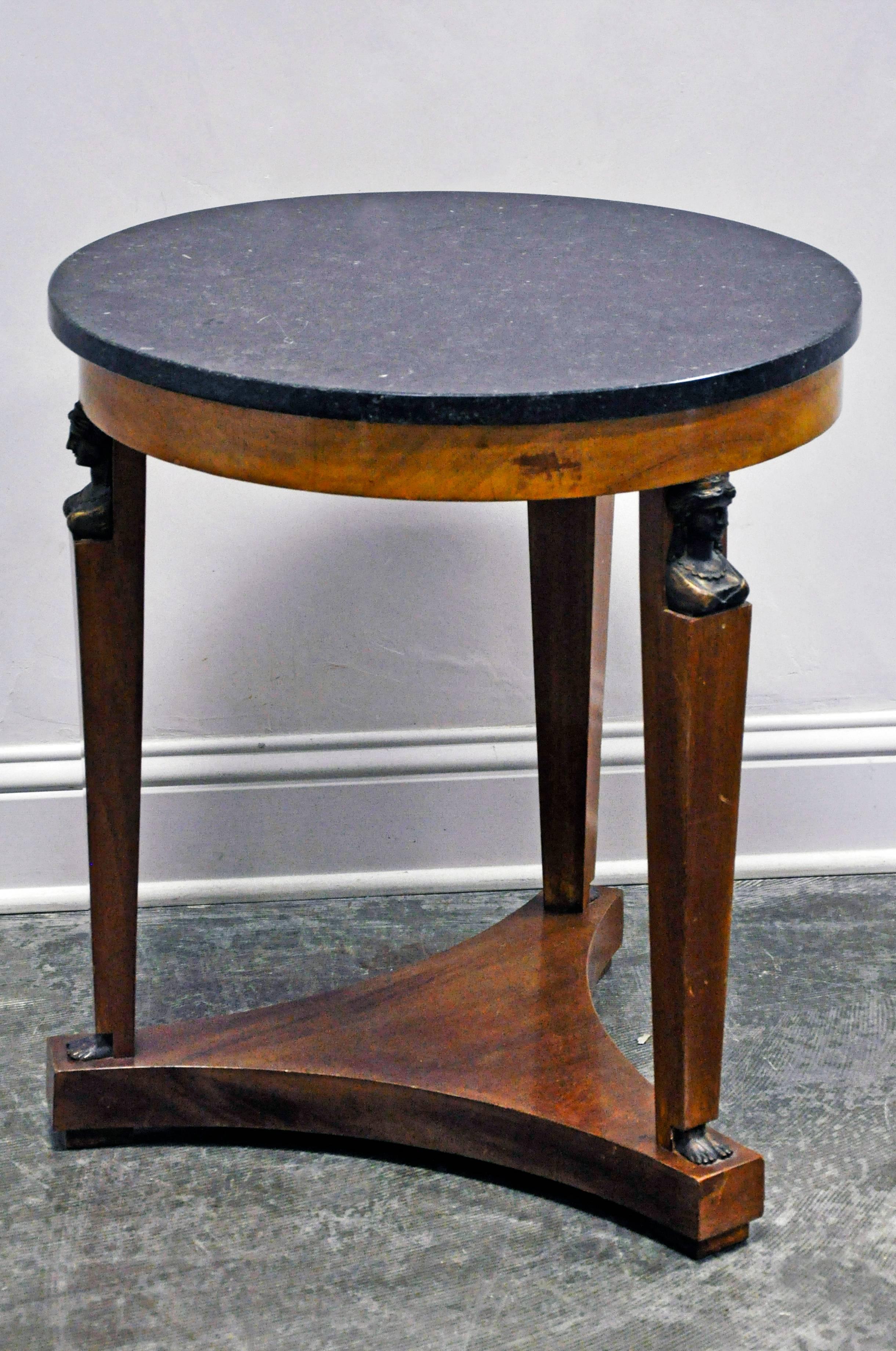 Classic Empire, occasional gueridon with lovely fruitwood veneer top set on three solid wood legs with triangular, inwardly curved base supporting original marble top. Female bust and feet ornament each tapered leg with beautiful detail and patina.