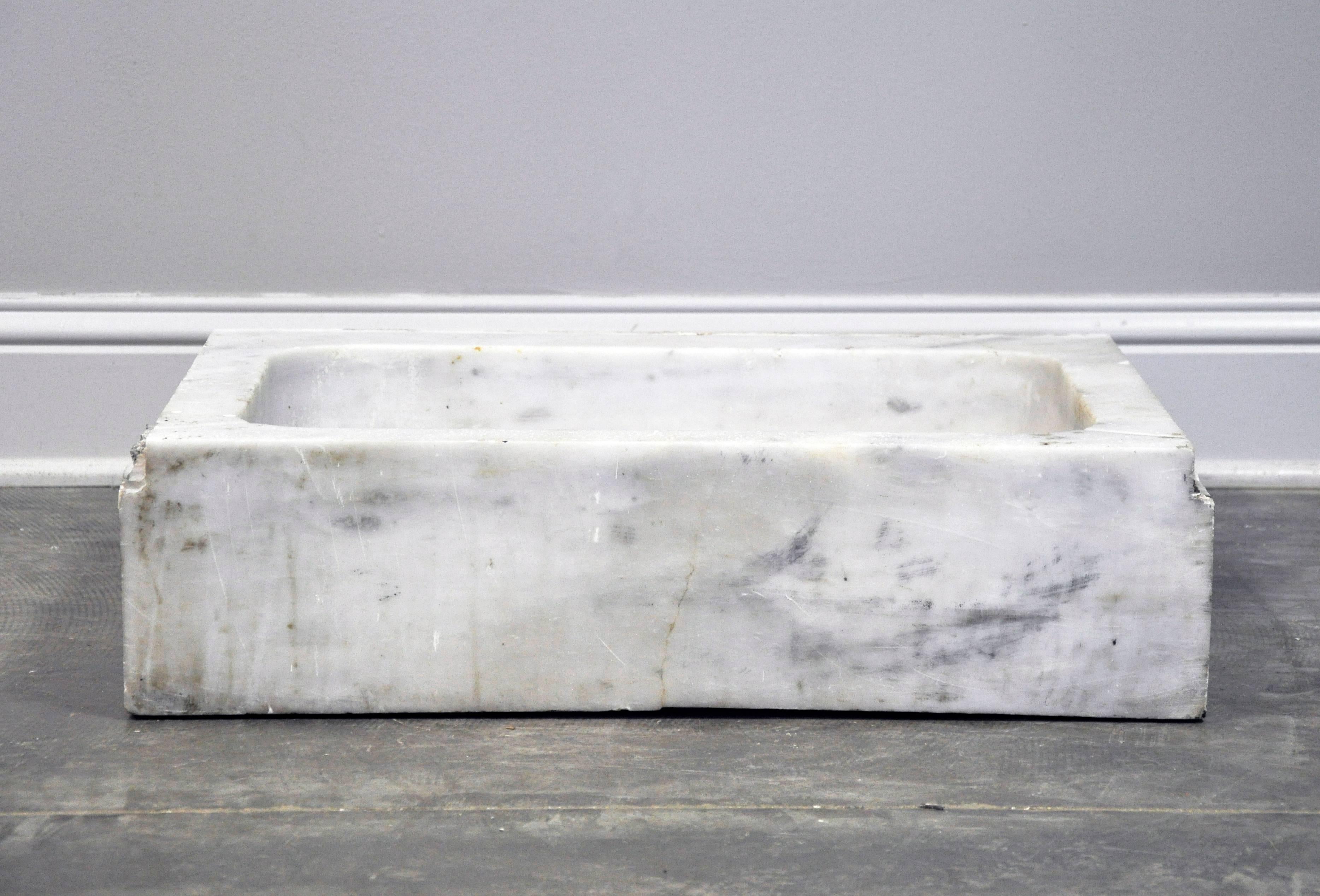 Fabulous vintage sink basin in white marble. Four smooth-cut sides with beautiful grey veining. Estimated 1920s-1930s when running water became prevalent in homes. Includes pre-cut hole for drainage fixture. Inside measurements are 21 1/4