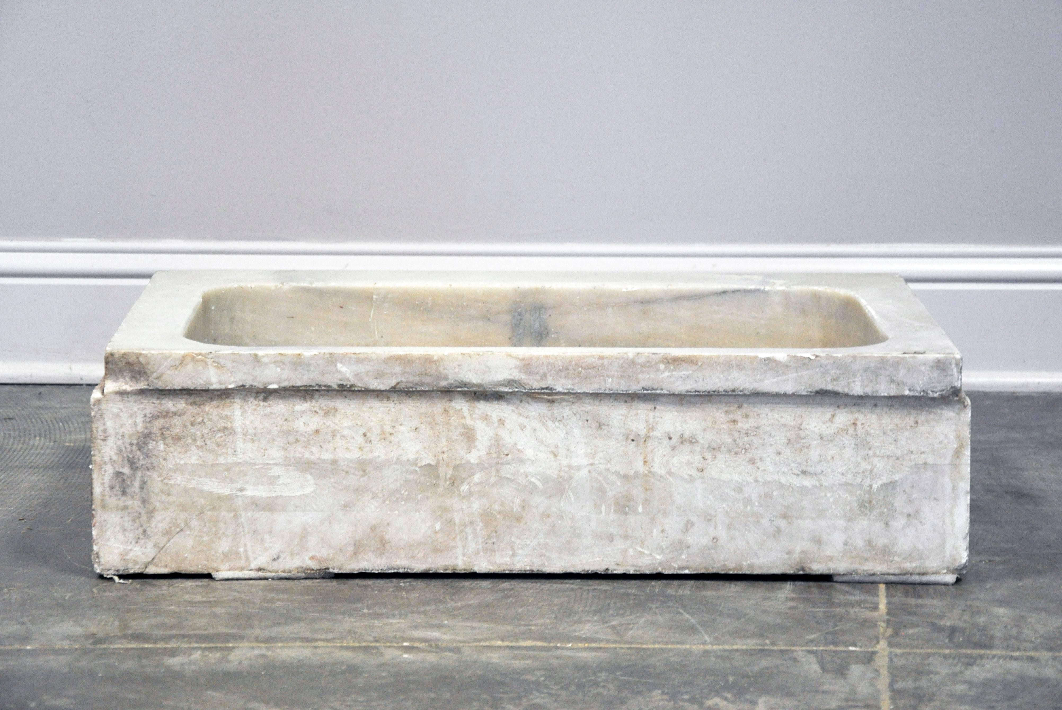 Fabulous vintage sink basin in white marble. Four smooth edges and carved front ledge with beautiful grey veining. Estimated 1920s-1930s when running water became prevalent in homes. Includes pre-cut hole for drainage fixture. Inside measurements