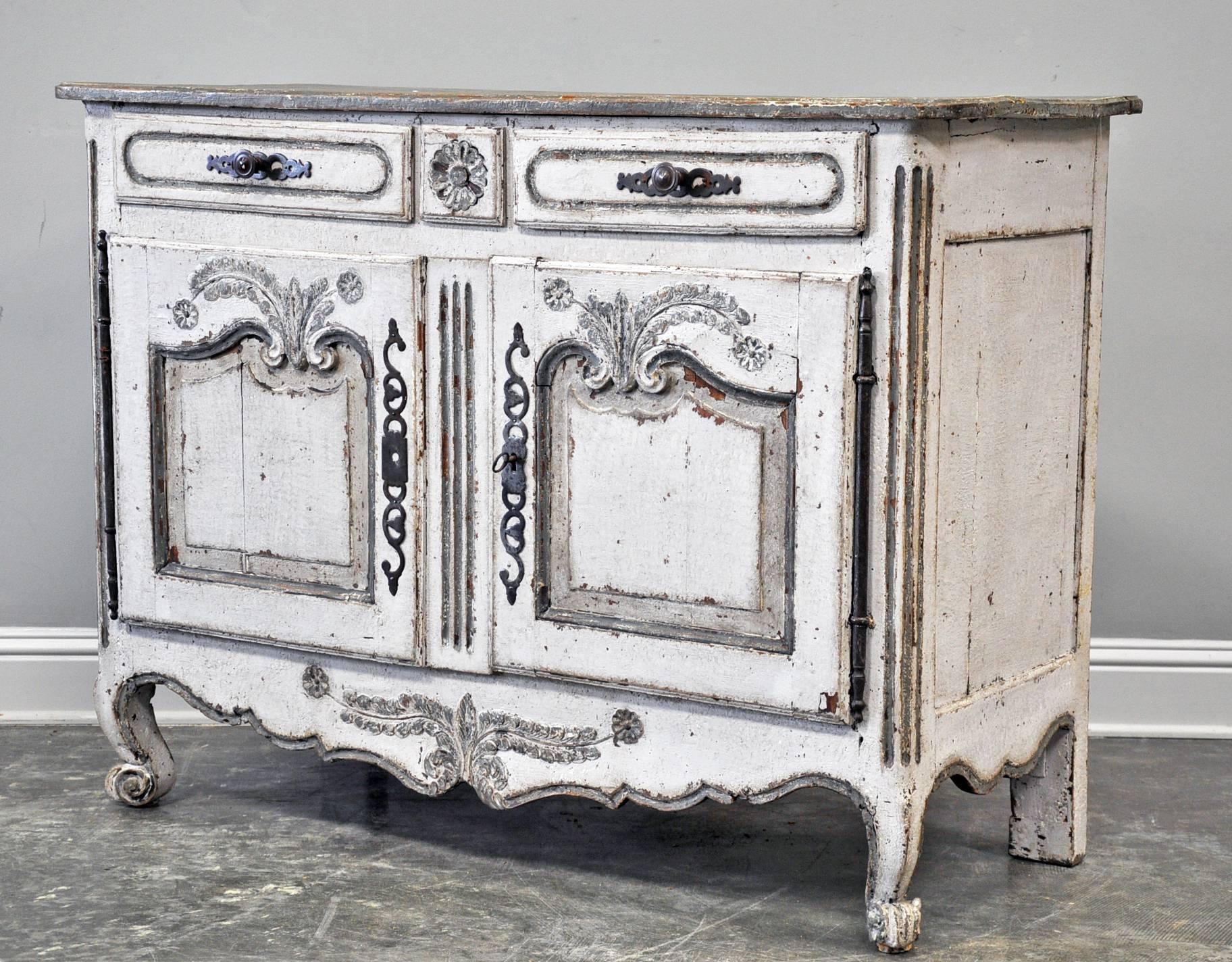 Provincial two-door buffet with two drawers painted in soft off-whites and grays. 

Established in 1979, Joyce Horn Antiques, ltd. continues its 36 year tradition of being a family owned and operated business specializing in hand procured, fine