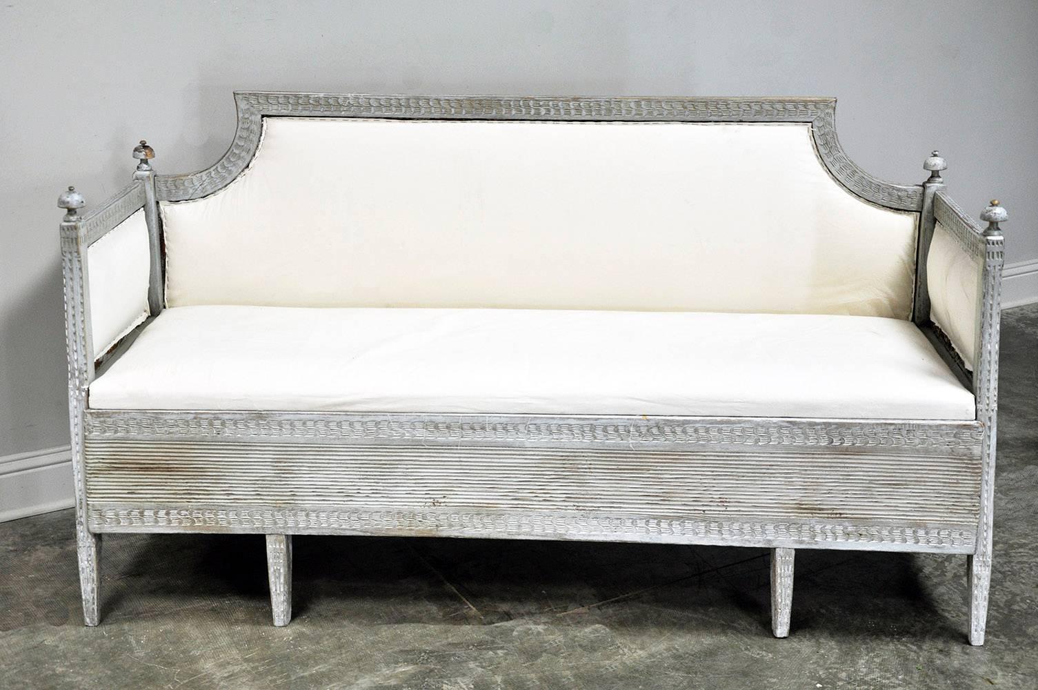 Classic Swedish daybed in Gustavian style with painted finish, upholstered in muslin. The primary wood is pine.

Established in 1979, Joyce Horn Antiques, Ltd. continues its 36 year tradition of being a family owned and operated business