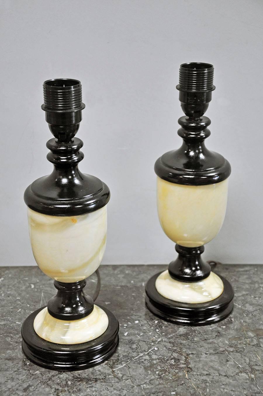 Pair of petite 20th century marble lamps with linen shades. Beautiful cream and ivory stone veining mounted on lacquered wood. Not wired to US standards. Lamp base measures 4.5" D x 10" H. Shade measures 12" D x