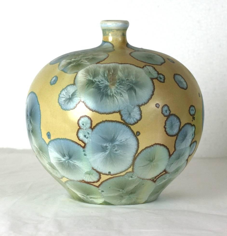 Elegant thrown porcelain vase with an expansive and vibrant aquamarine crystalline glaze on a sand colored base by master French ceramist Taxile Doat, from the University City Porcelain Works in St. Louis, circa 1912.
A wonderful example of the