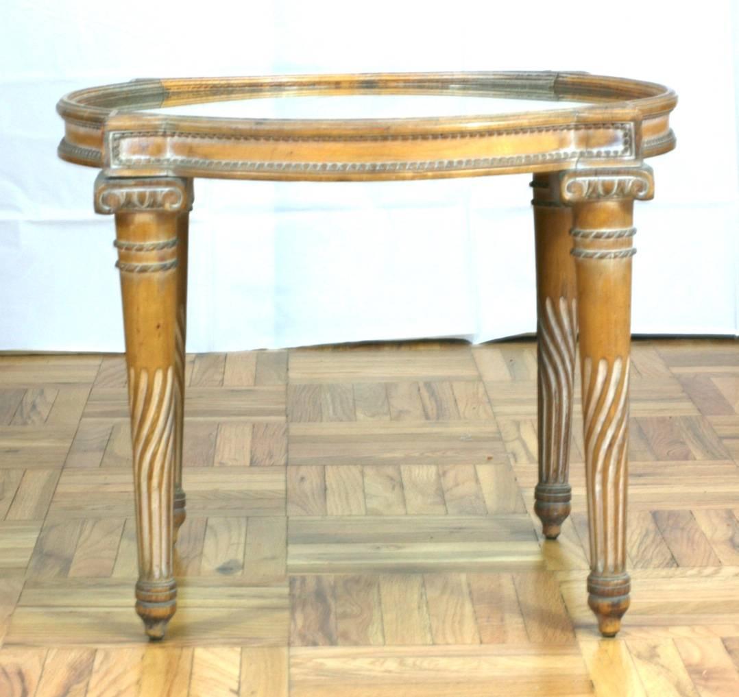 Attractive and decorative neoclassical revival mirrored side table of carved and patinaed wood, possibly maple.
Lovely design with mirrored top which has nicely patinaed with column form turned legs,
circa 1940s, USA.
 