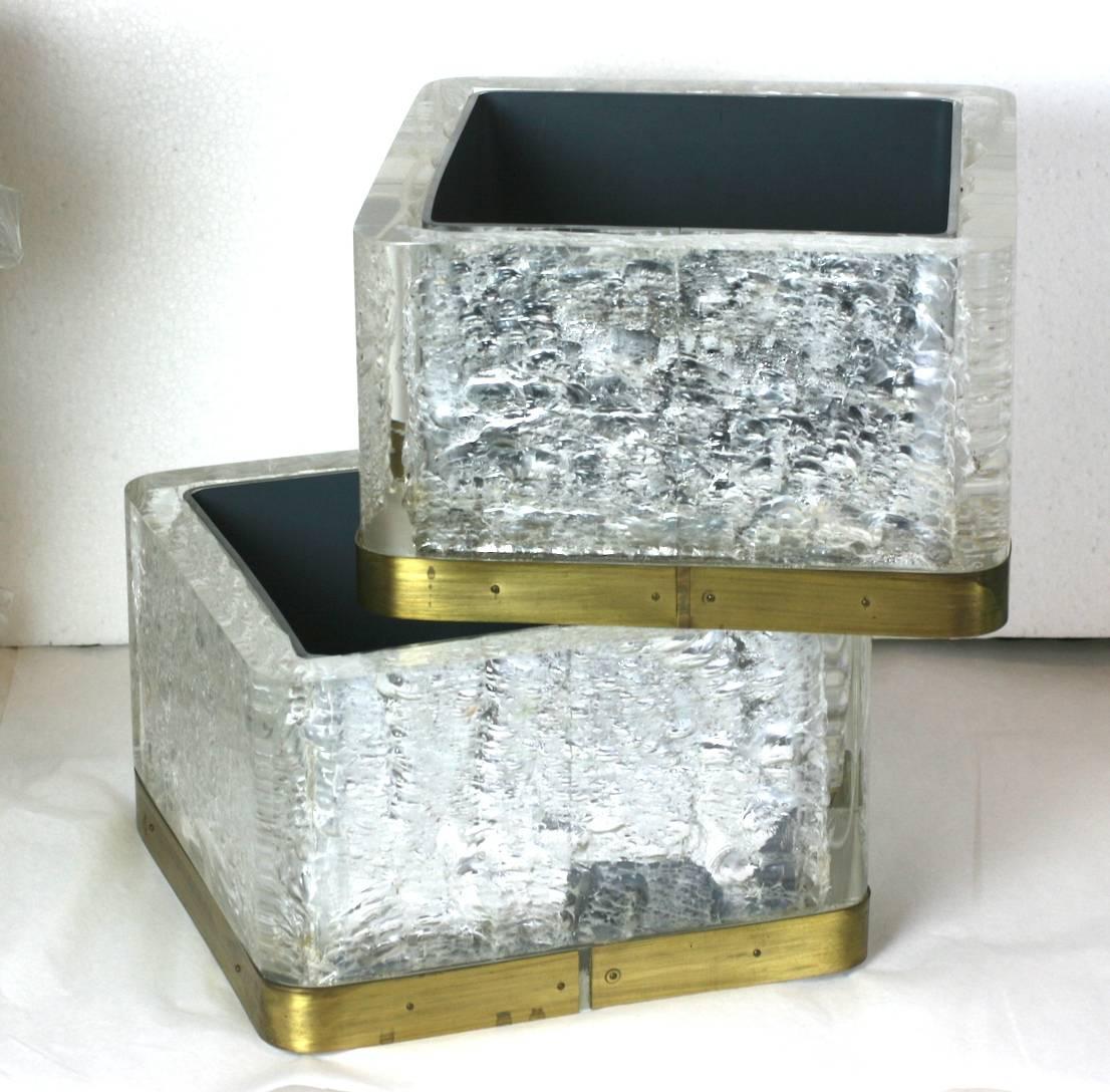 Interesting textured and mirrored Lucite suite composed of two table plant boxes, a pair of wall mounted planters, and a half table surround in the same material.
These were custom made for a Modernist home in Westchester, New York which had a