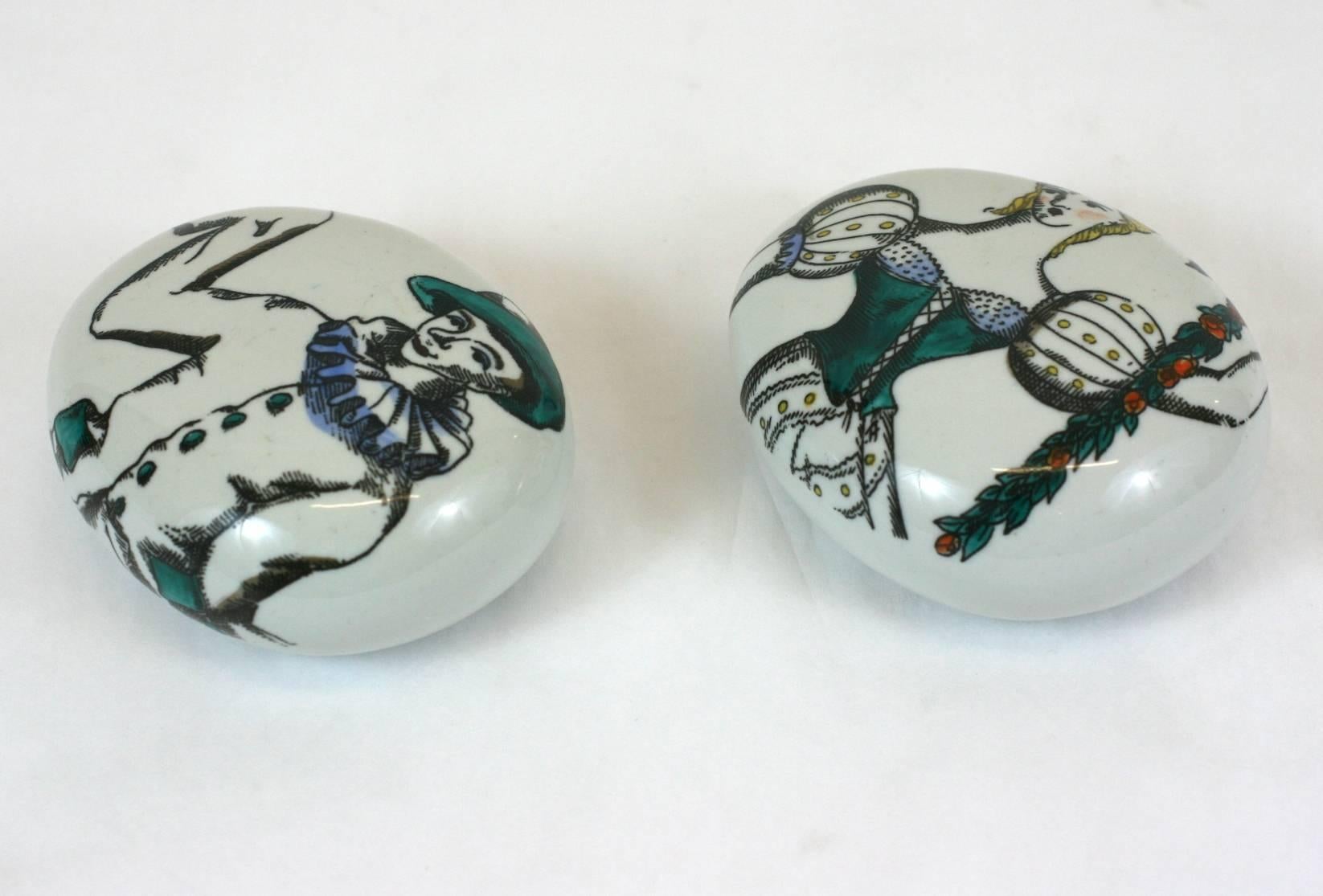 Pair of porcelain Fornasetti pebble paperweights. 

Motifs: Commedia dell'Arte by Piero Fornasetti

Measures: 4