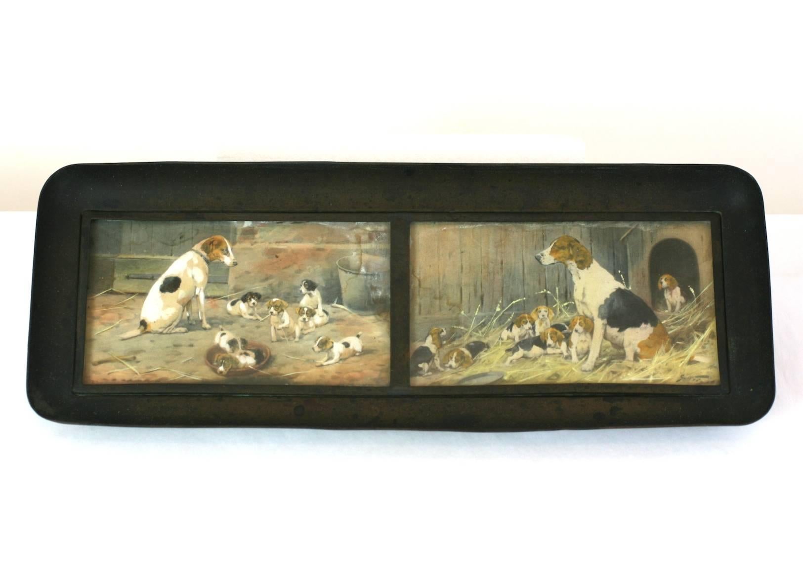 Hand painted bronze pen tray with wonderful watercolor barnyard scenes of hounds with their large litters. Beautifully painted watercolor panels set under glass panels for protection. Heavy, simple bronze mount. 1910's USA. 
Very good condition.