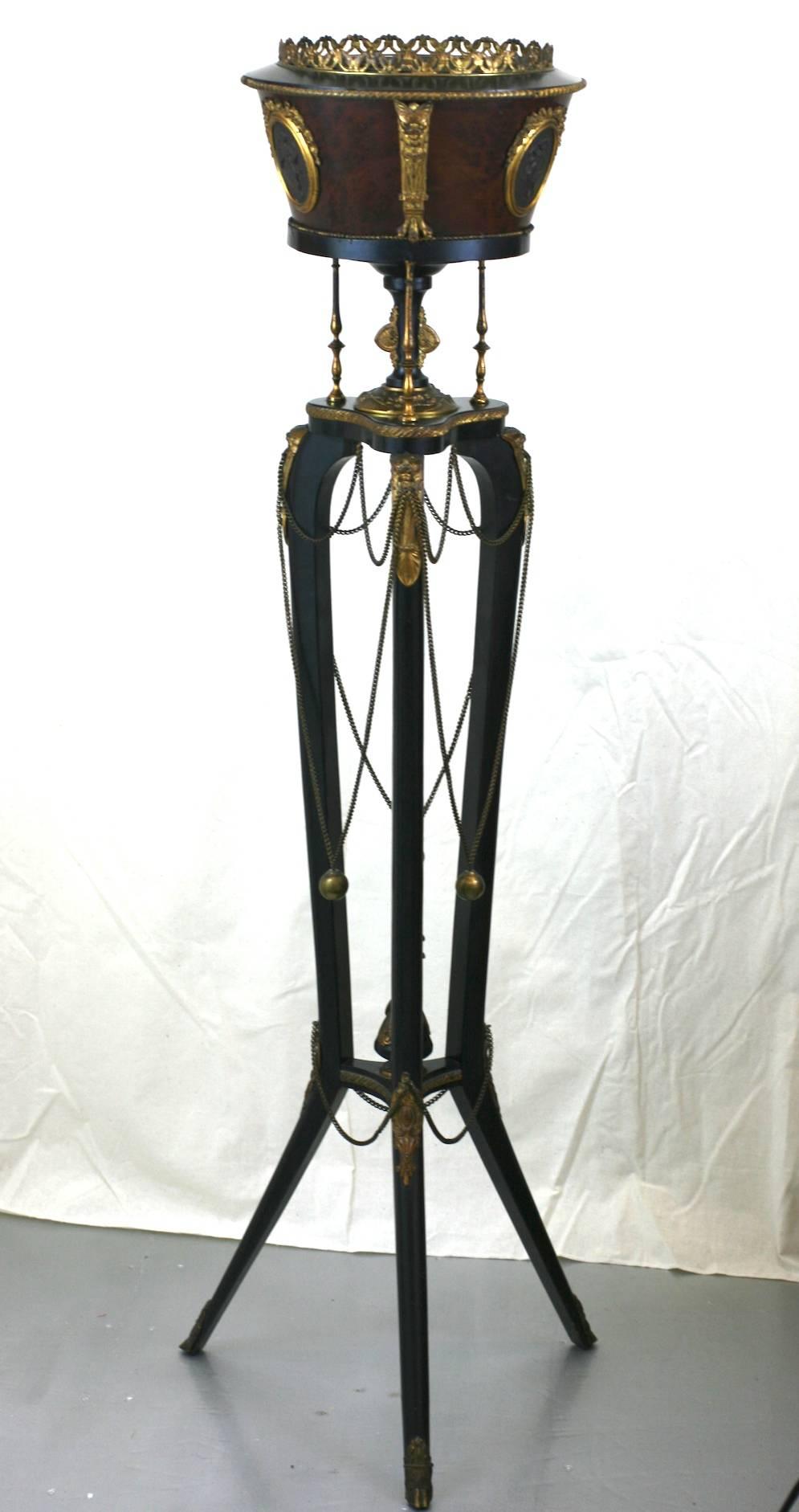 Tripod fern Stand of ebonized wood, burl veneer and mahogany in the Napoleon III style, which is the name commonly given to a 19th century style of Renaissance Revival that encompasses a myriad of Revivalist styles including Louis XVI, and
