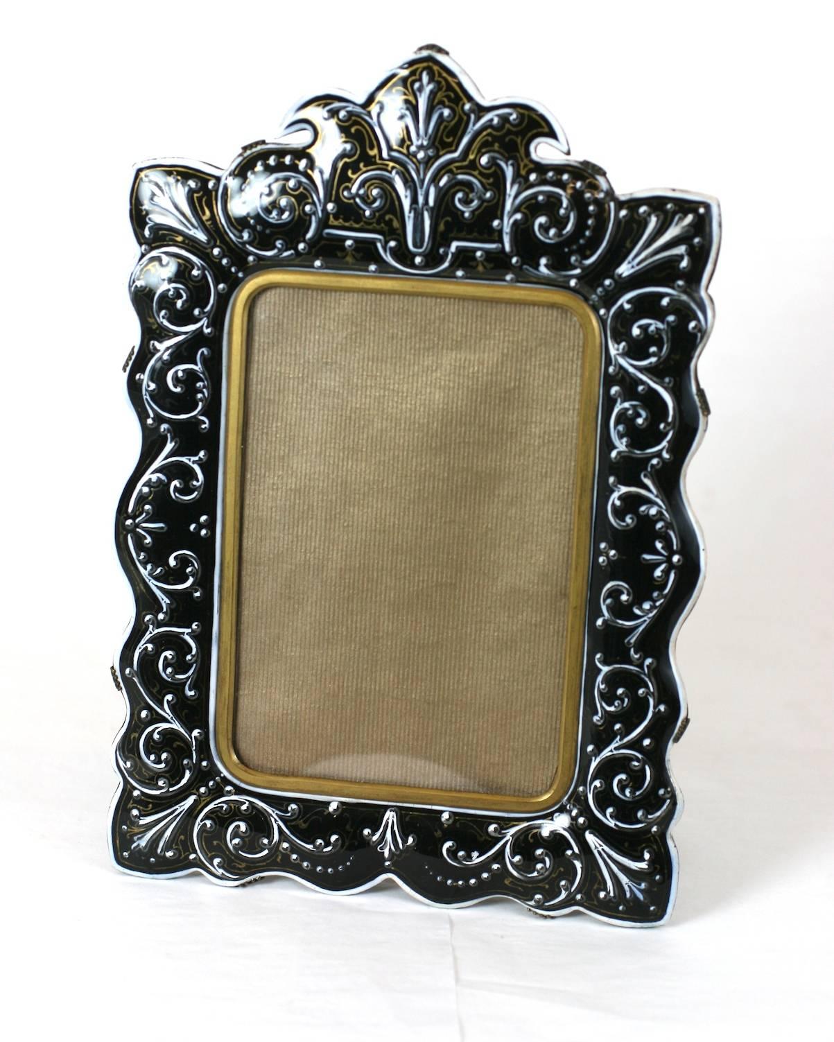 French enamel bronze frame, hand-painted in black and white with gilt accents. Late Victorian, high quality. The front enameled panel is held by prongs to the backing and easel, 1880s, France. Excellent condition. Measures: 9