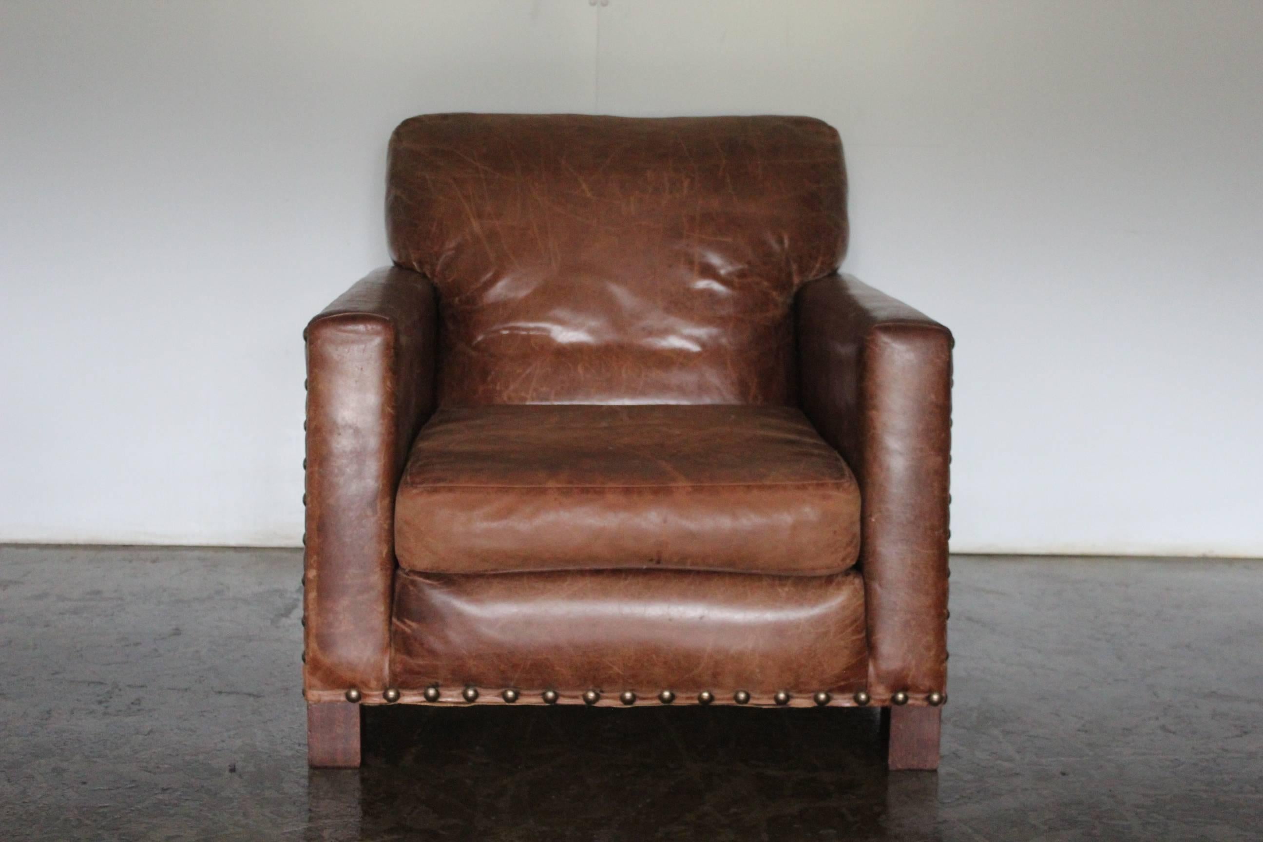 On offer on this occasion is an incredibly rare, and beautifully-presented Ralph Lauren “Club” chair and ottoman, dressed in a peerless top-grade brown Regency leather and with antiqued-brass nailhead detail.

As you will no doubt be aware by your