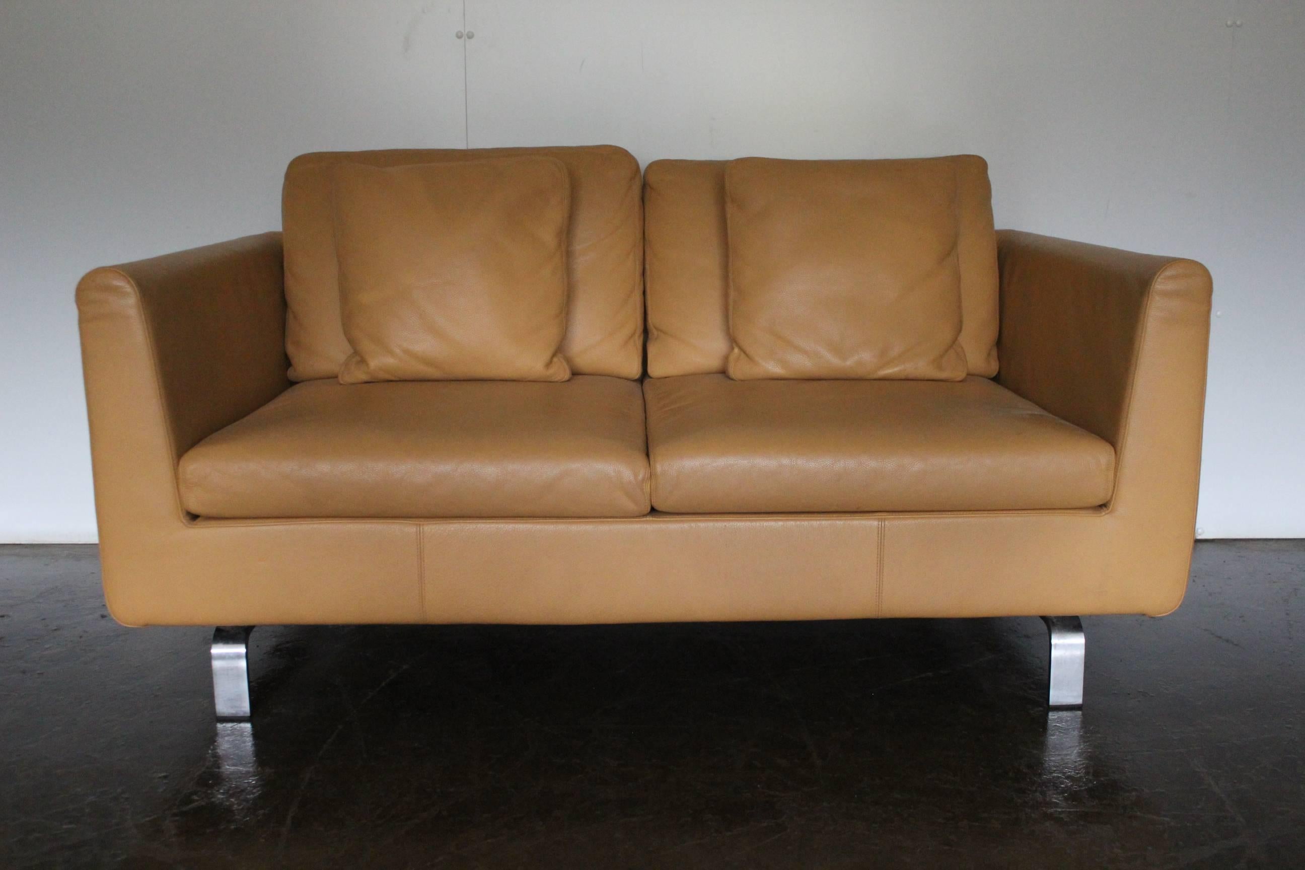 On offer on this occasion is a rare, pristine pair of two-seat sofas, from the world renown German furniture house of Walter Knoll, dressed in a sublime matt Pale-Tan leather, and with Matt Polished-Steel framework.

As you will no doubt be aware