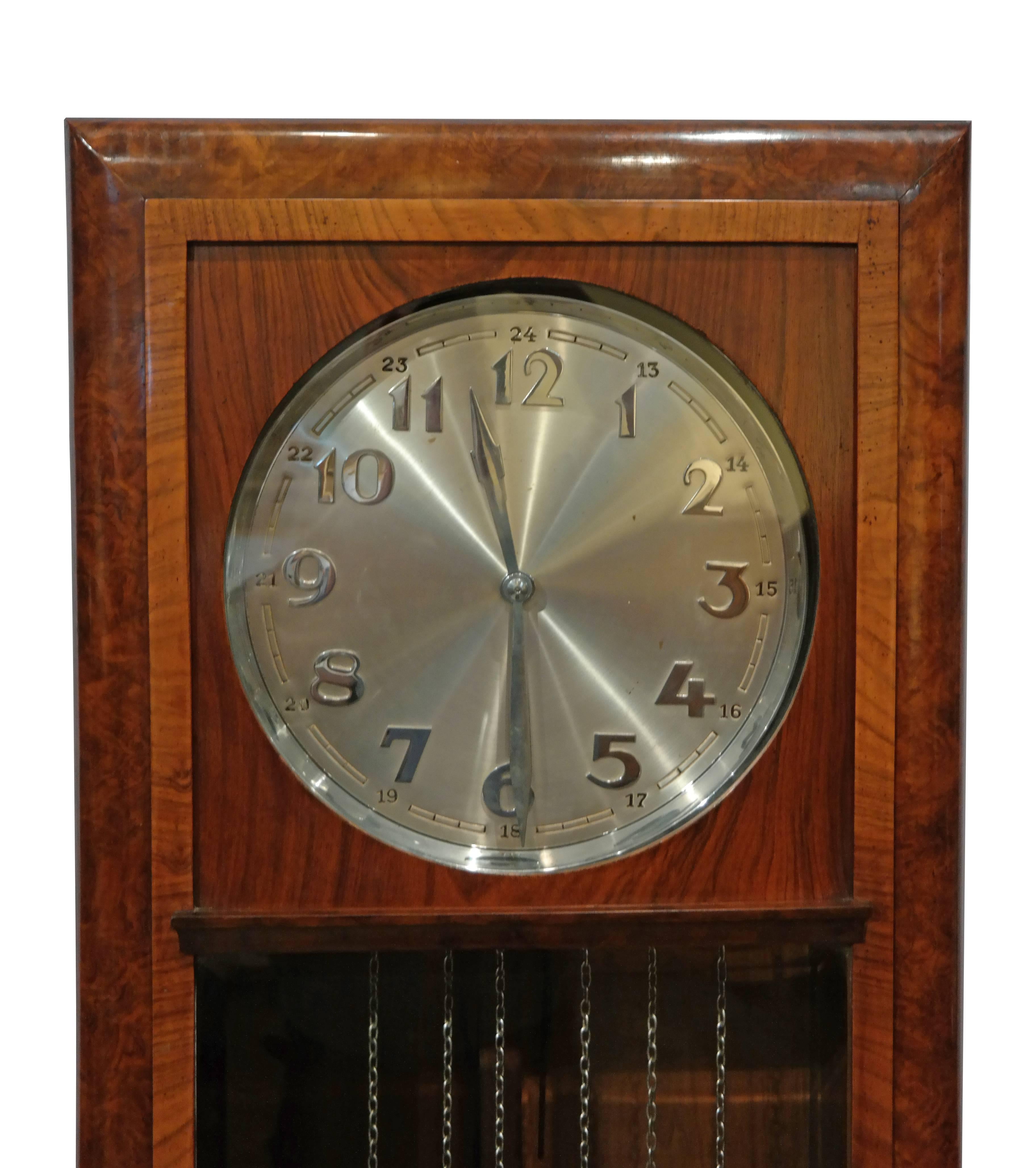German Art Deco grandfather clock, with stainless dial and highly decorative case in walnut and rosewood. Clock has been recently cleaned and is in good working order.