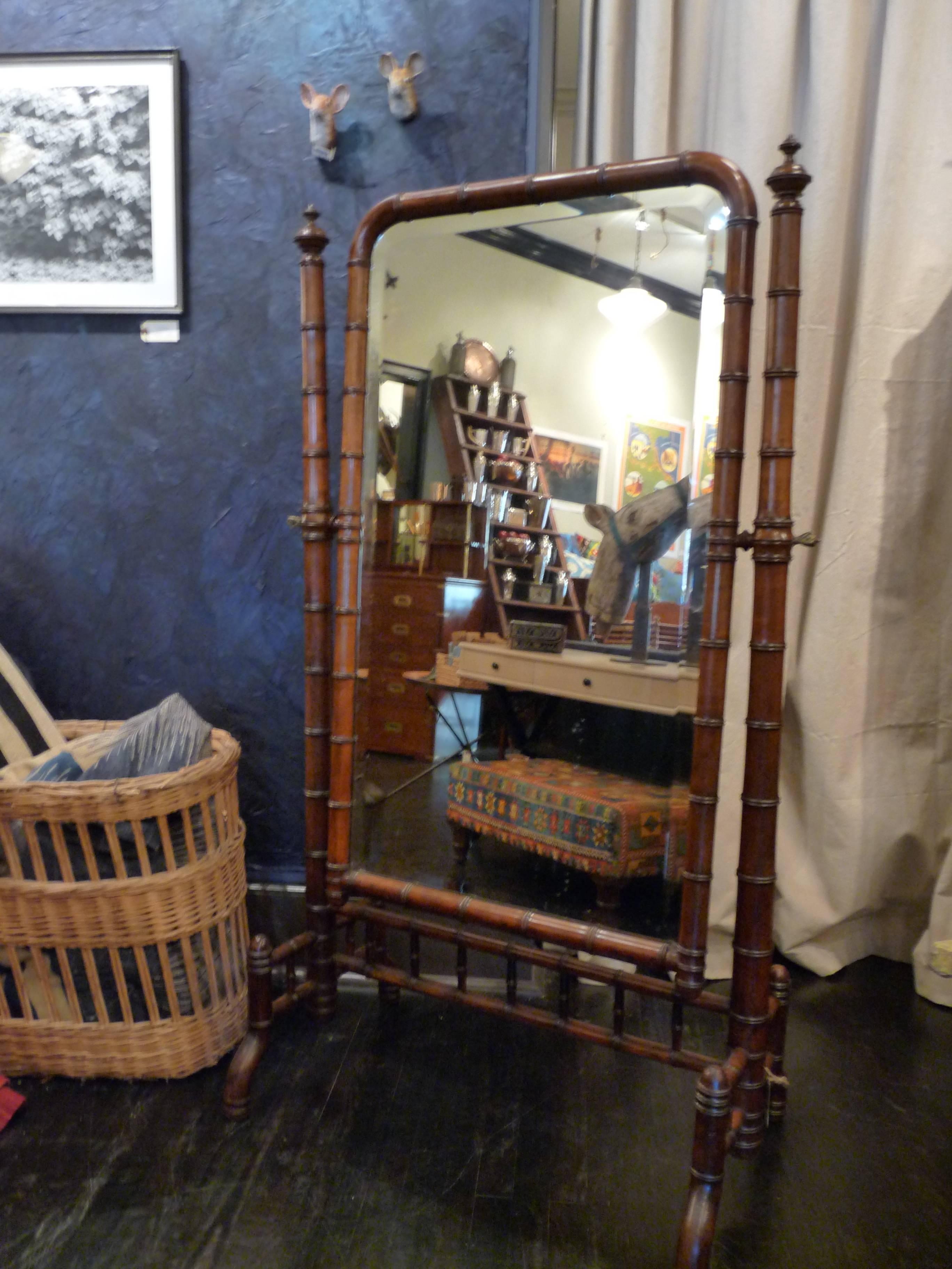 A great-looking French faux-bamboo full-length dressing mirror. Beautifully carved frame hold the original glass, which is in wonderful condition and is adjustable.. Very solid.