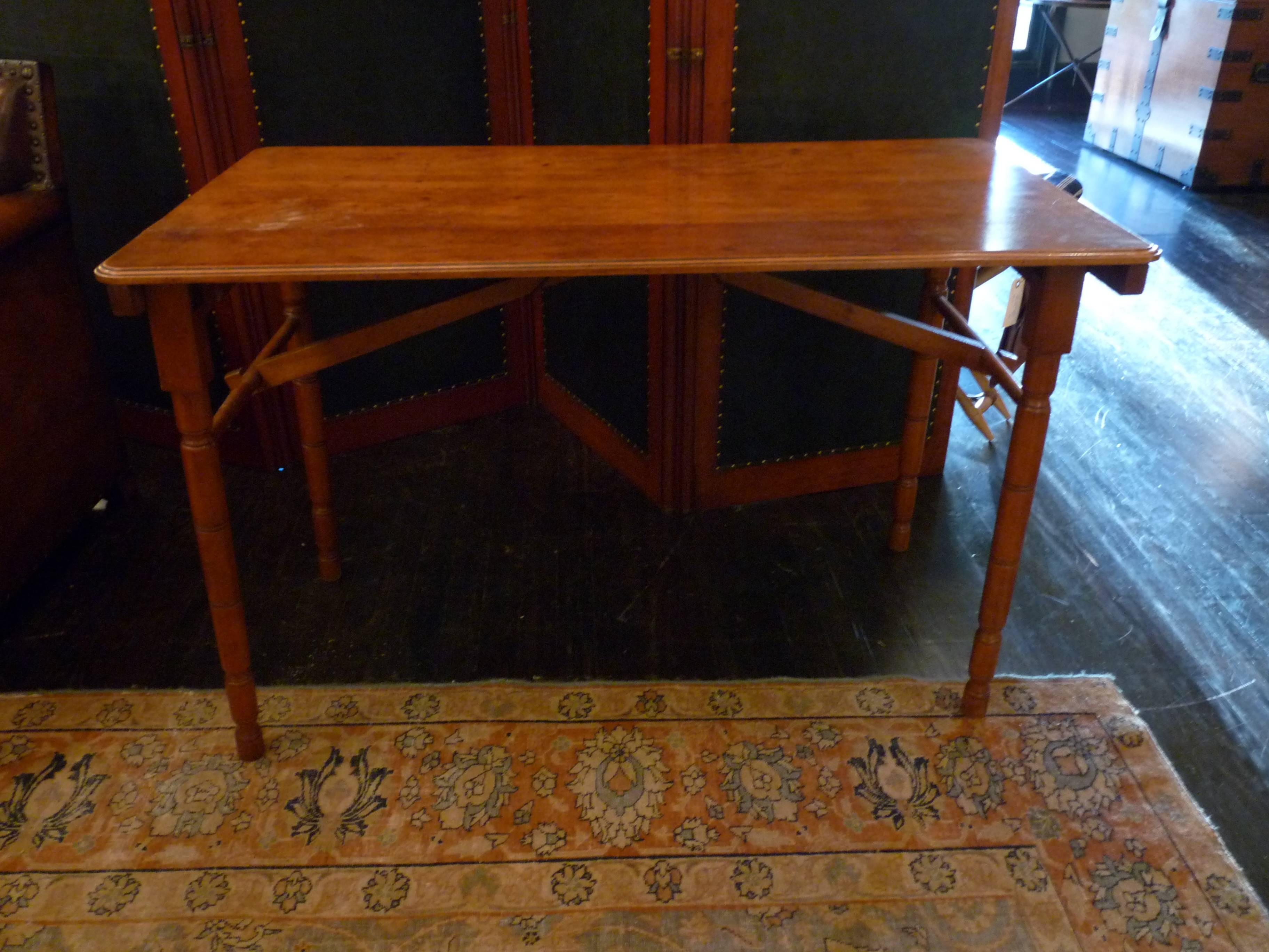 Fashioned out of mahogany, this late 19th century campaign folding table has likely traveled the world or at least graced the outdoor picnics of an English estate. Both practical and beautiful, this table is a great functional piece . 