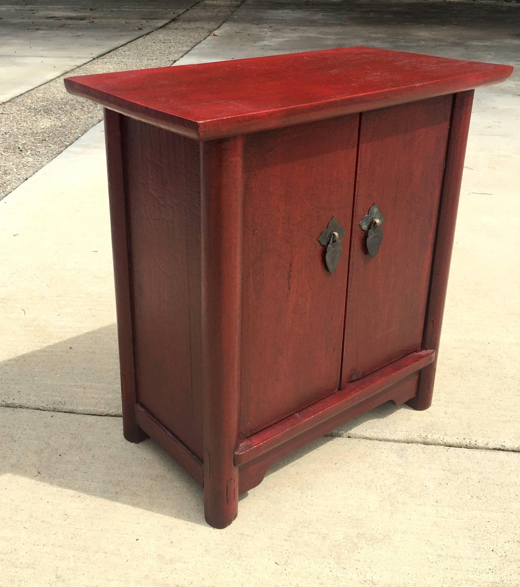 Beautiful 19th century little chest features a drawer and full storage, handsome fish hardware. The style is a typical Ming design. Gorgeous red lacquer crackle finish. 

Solid wood. Tenons and mortises. 

A versatile piece that can be used in