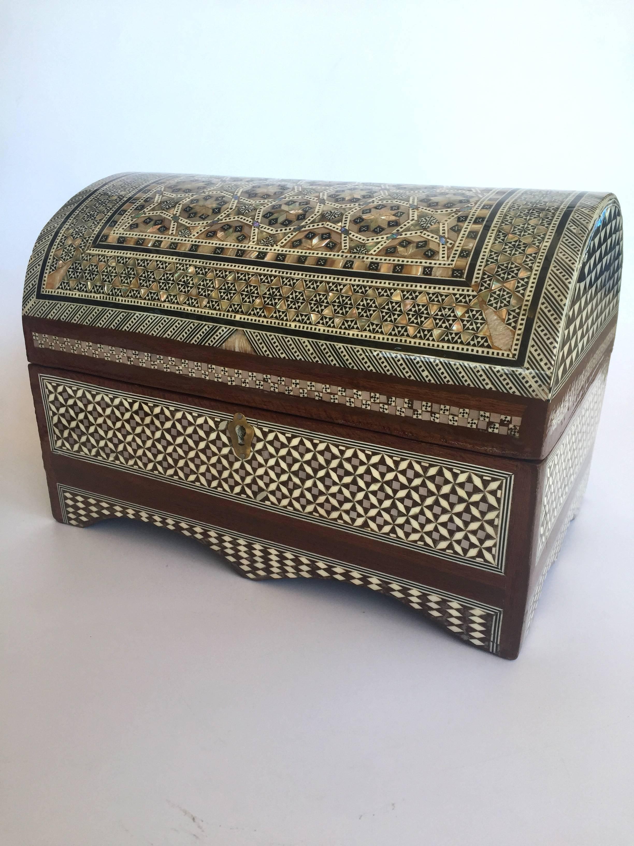 The craftsmanship on this beautiful piece is amazing. The wood box is entirely encrusted in genuine mother-of-pearl. The intricate pattern and fine precision makes it a true work of art. 

Two-tiered, lined with felt with lock and key.

Some