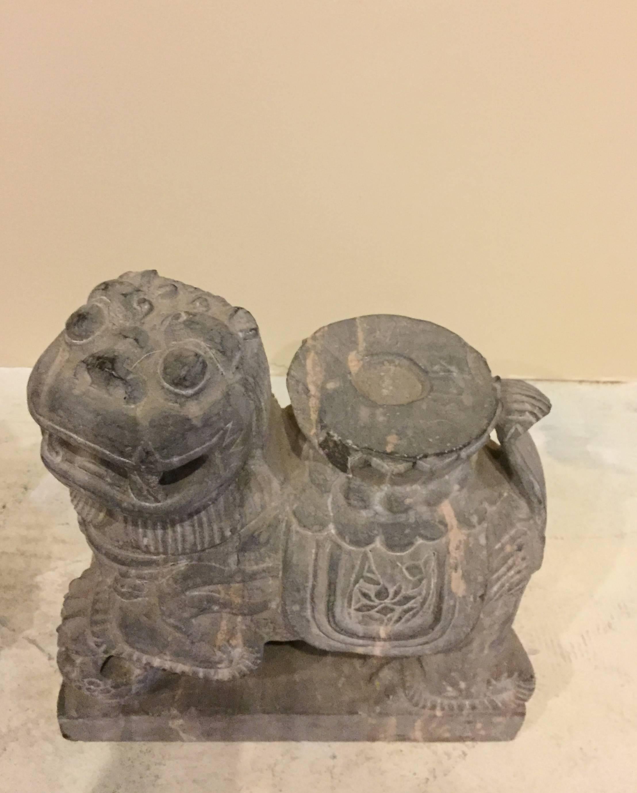 Wonderful pair of foo dogs are hand carved out of solid granite. Details of lotus flowers can be observed on their saddles. A candle holder feature adds to their uniqueness.  These foo dogs have very adorable, happy expressions. Foo dogs are