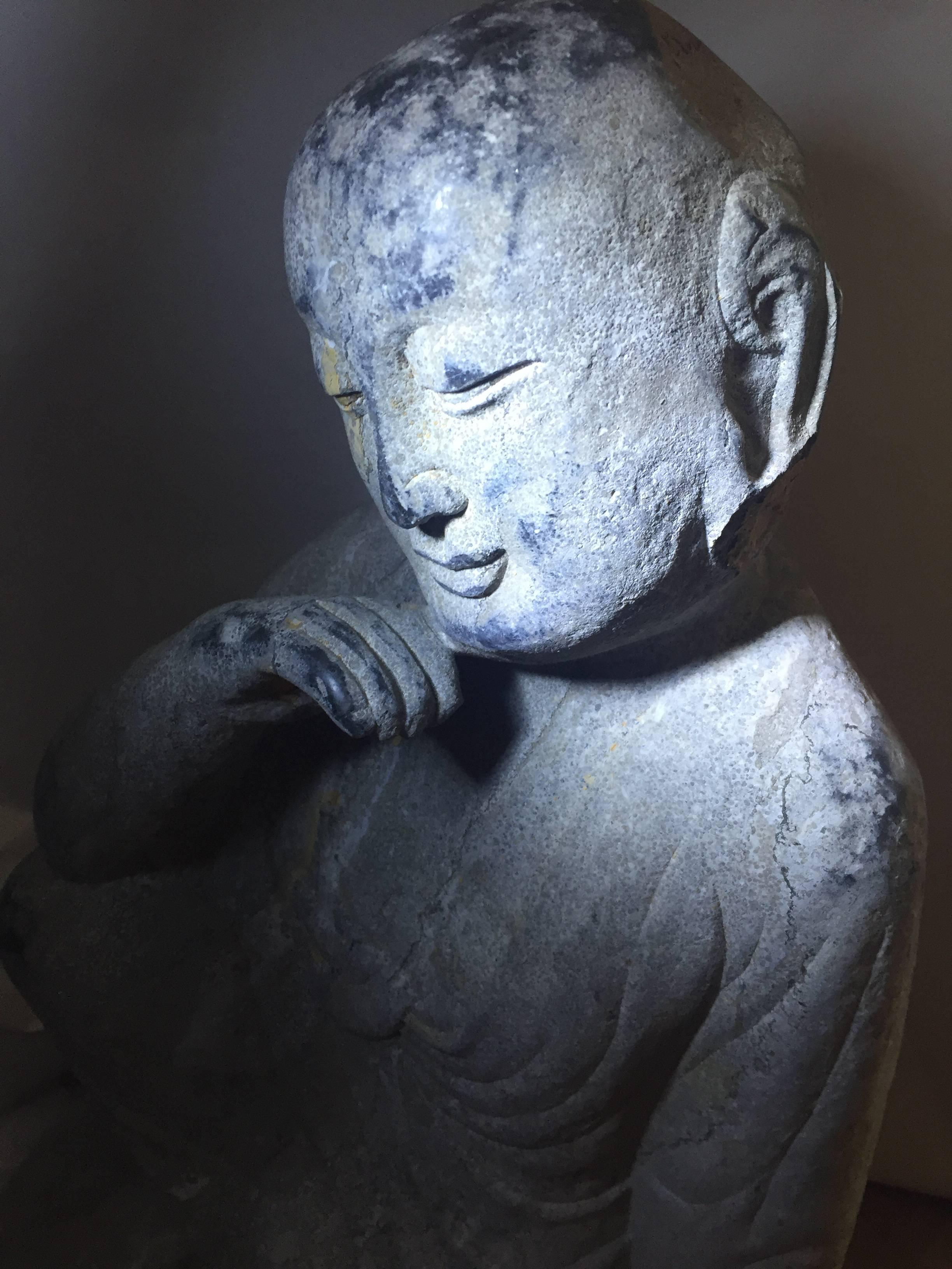 This rare 19th century piece depicts Buddha in contemplation. Carved out of solid stone, the sculpture demonstrates wonderful artistry at the same time extrudes a sense of therapeutic calmness.