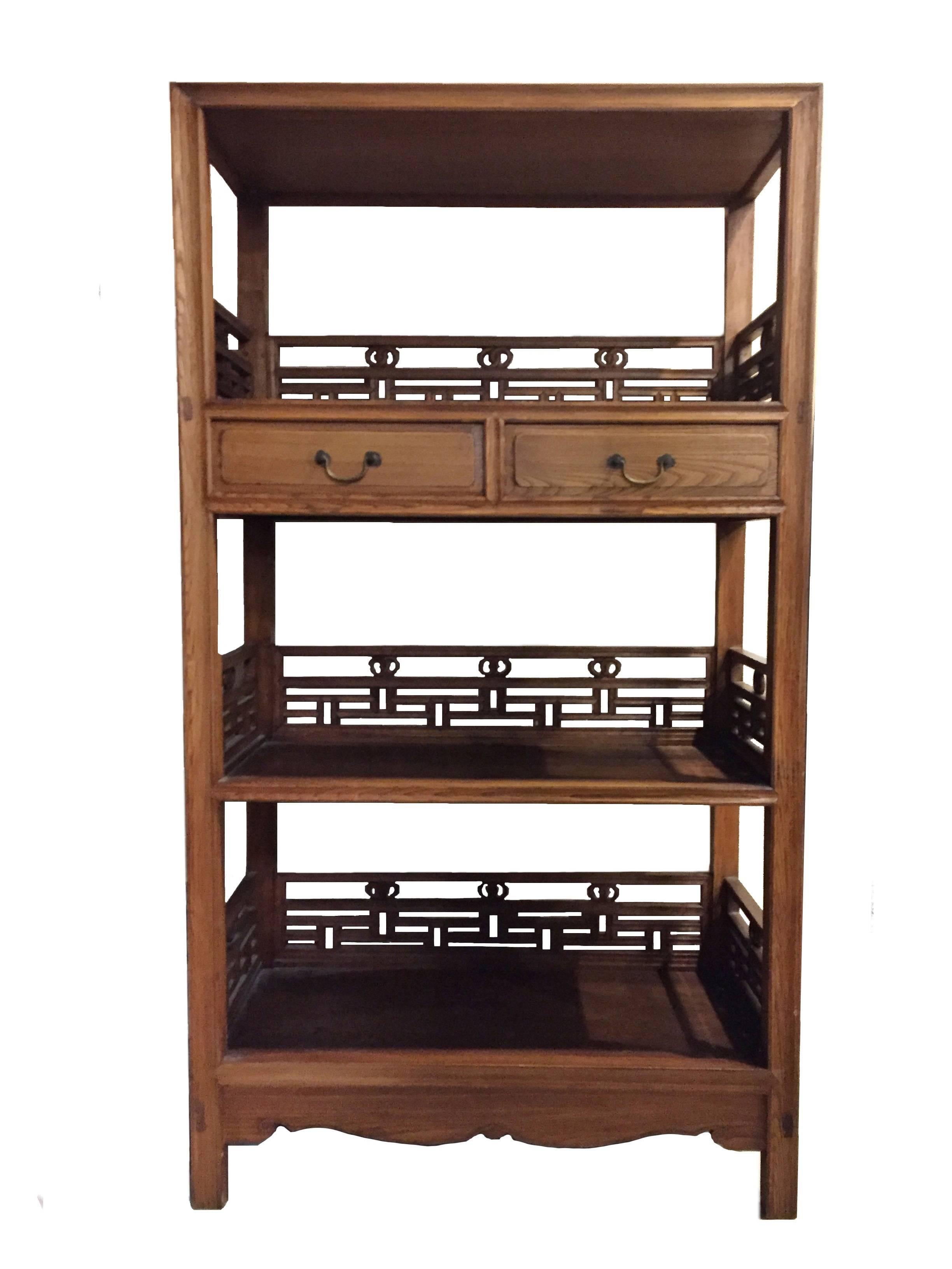 Here we have a pair of very handsome elm wood book cases. The design is clearly of Ming origin, with its simple, straight lines void of decoration. The choice of wood and skill of the craftsman become critical in such a design for such a function,
