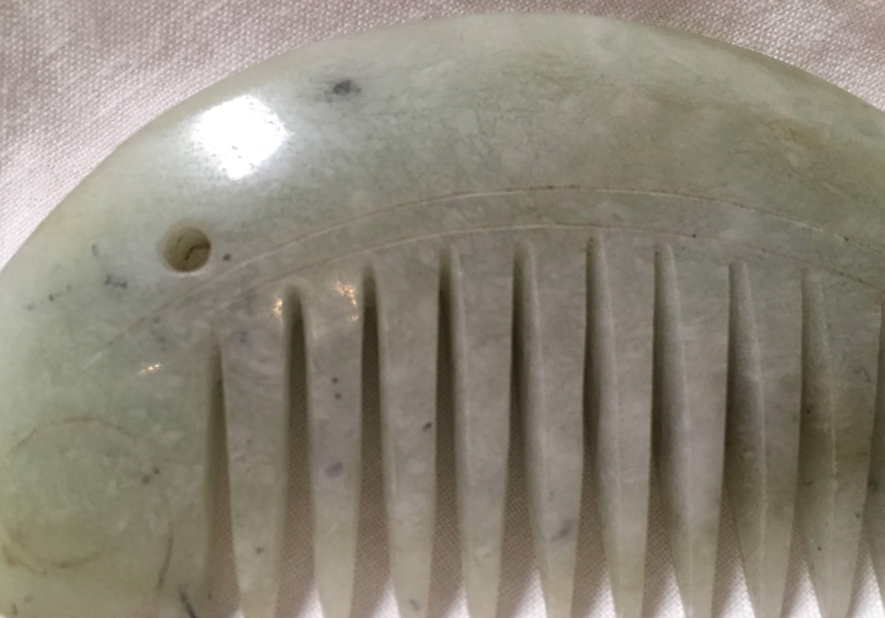 This beautiful piece is one of the most special in our antique jade collection. 

The comb is in the shape of a crescent in sync with the Chinese belief of 