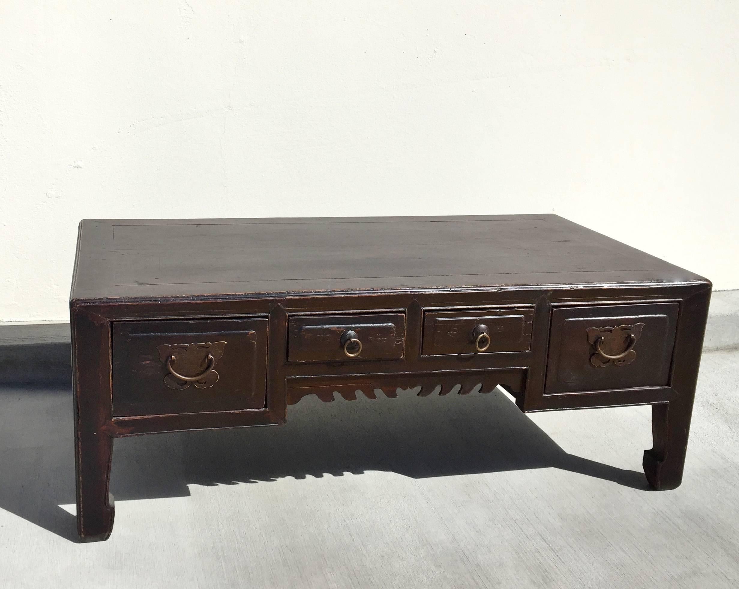 19th century Chinese low table features four full length drawers adorned with bronze butterfly hardware. Beautiful hoof legs give the nod to Ming dynasty. 

Perfect coffee table or as a stand for your sculpture or statues. Back of the table is