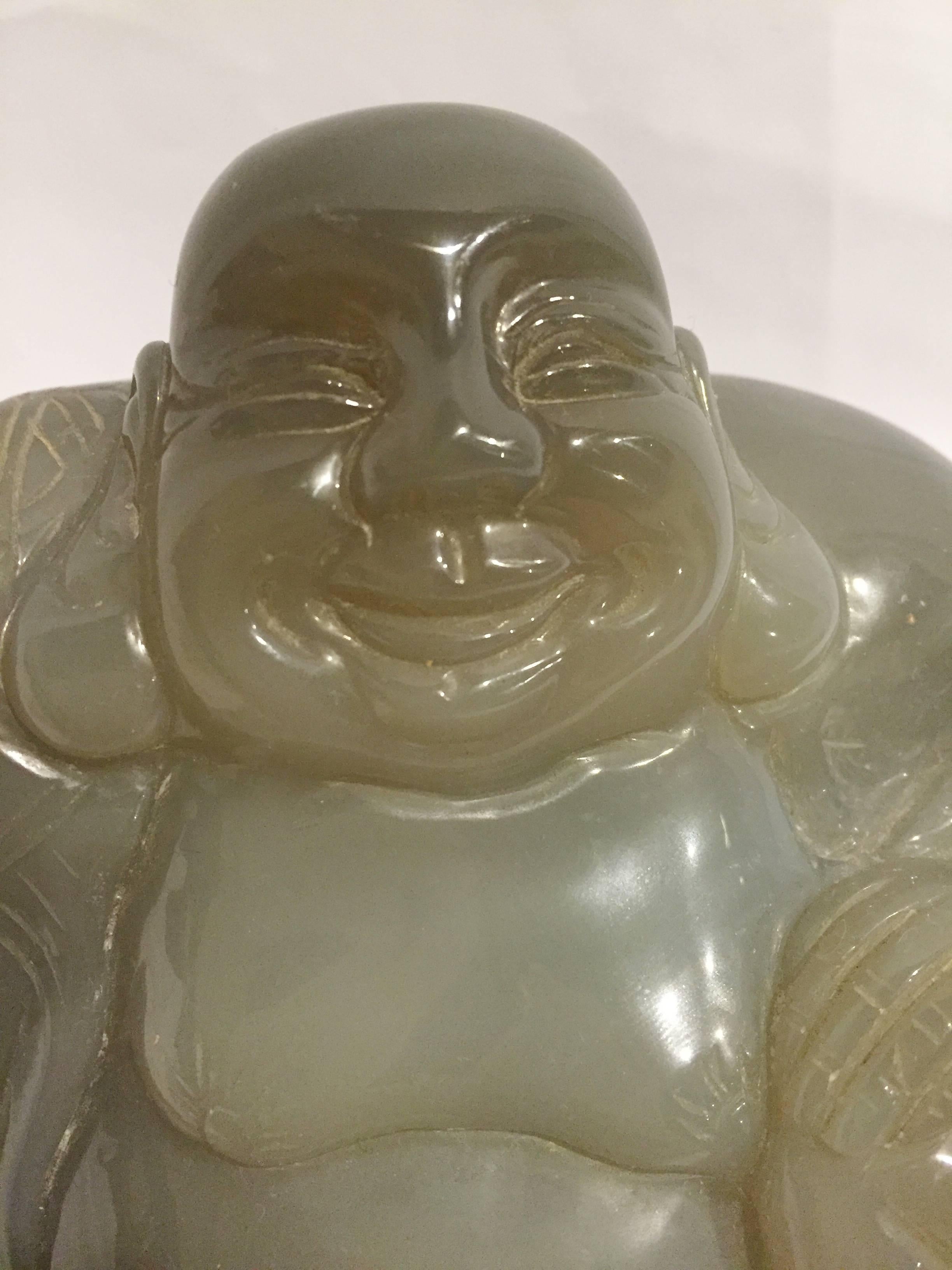 This is an exceptionally large and first grade natural agate specimen that is hand-carved into a beautiful Happy Buddha. 

The depiction is fine with details on the robe and facial features. The sculpture reflects agate's natural luster. 

One
