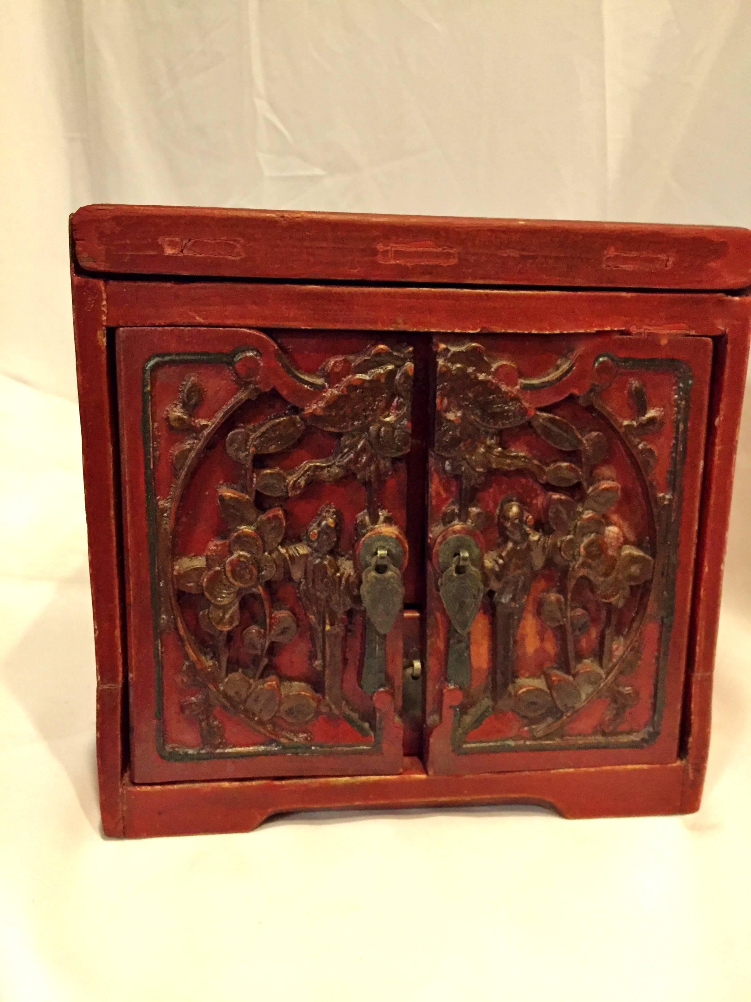 Beautiful red lacquer jewelry box features three very long, full length drawers. Top carved panel is removable for additional storage and display of jewelries. Carved figures are Gods of Harmony symbolizing happiness and harmony. Butterfly crossing