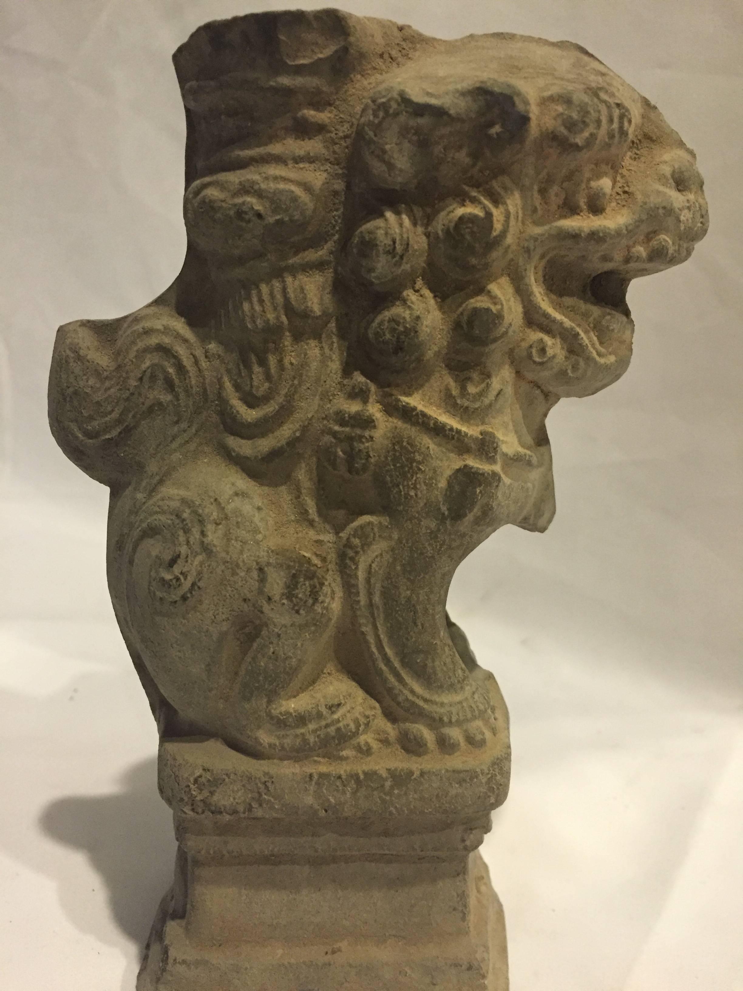 This is a very rare piece from China's northern frontier Shanxi province. The candle holder is of a brick, terracotta material. Very Fine details can be observed on the foo dog, which include its curly hair, bells on his collar and decorated saddle.