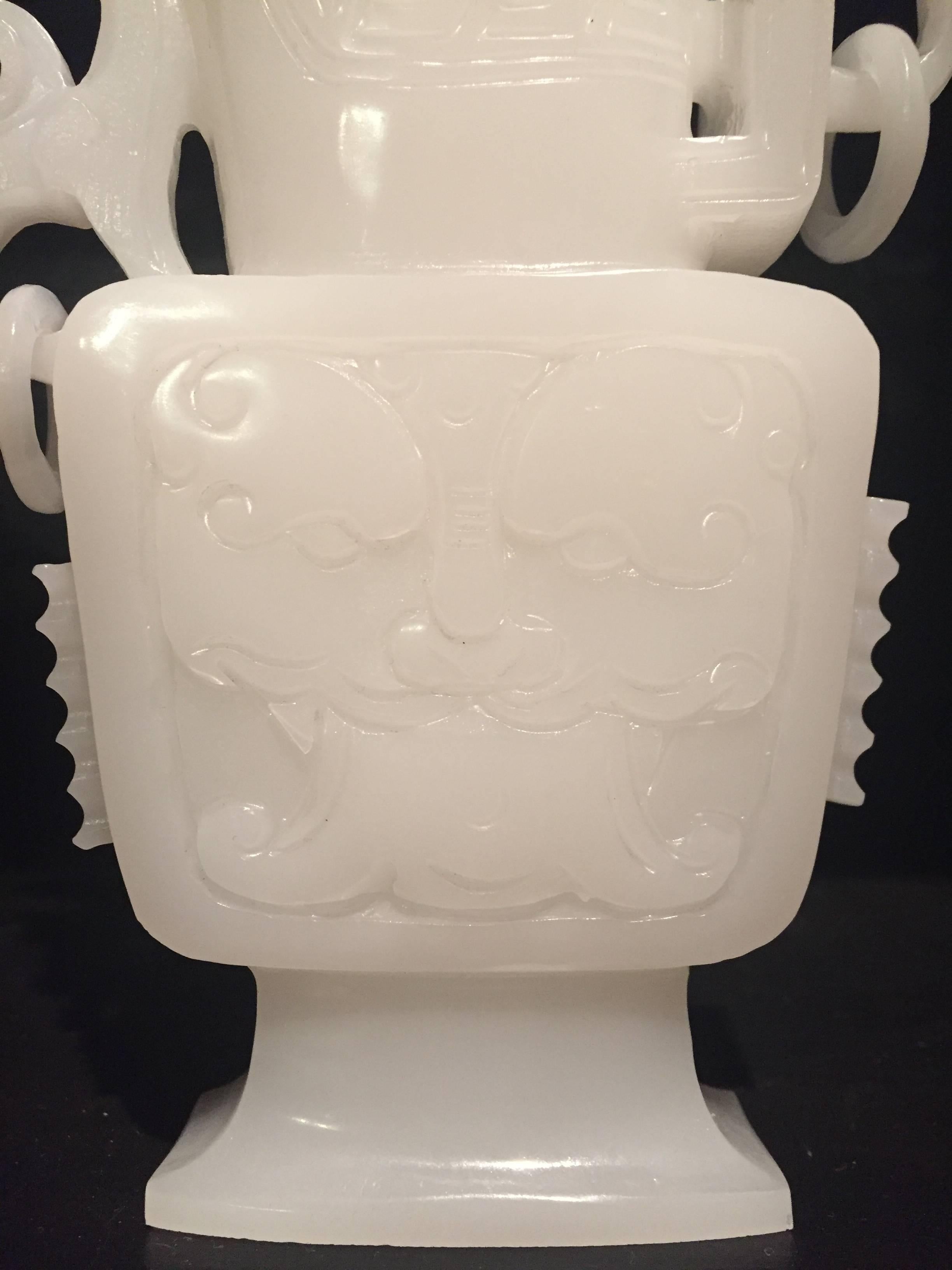 Extraordinary solid white jade in the shape of Zun, an ancient wine drinking vessel used by noblemen. Its color is pure paper white, with no gray, beige or green undertone (spout is pure white too, the gray shown in the photos are shadows). The