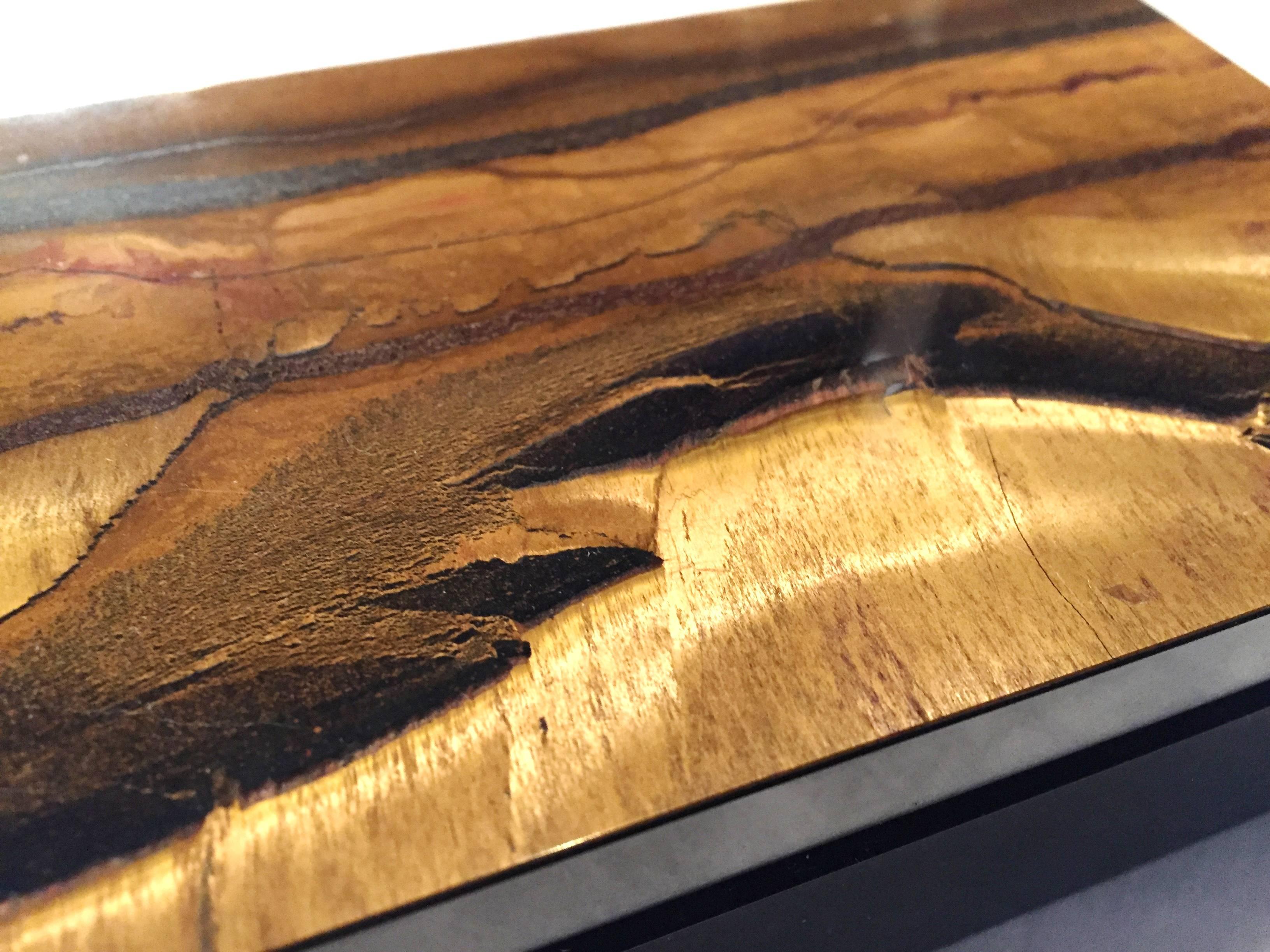 A stunning, completely handmade box made with brilliant Tiger Eye. The shimmering gem tone displays an intriguing picture of sand, sky, ocean, mountain, desert and caves. This is a very rare, highly valuable piece, as unlike most Tiger Eye boxes
