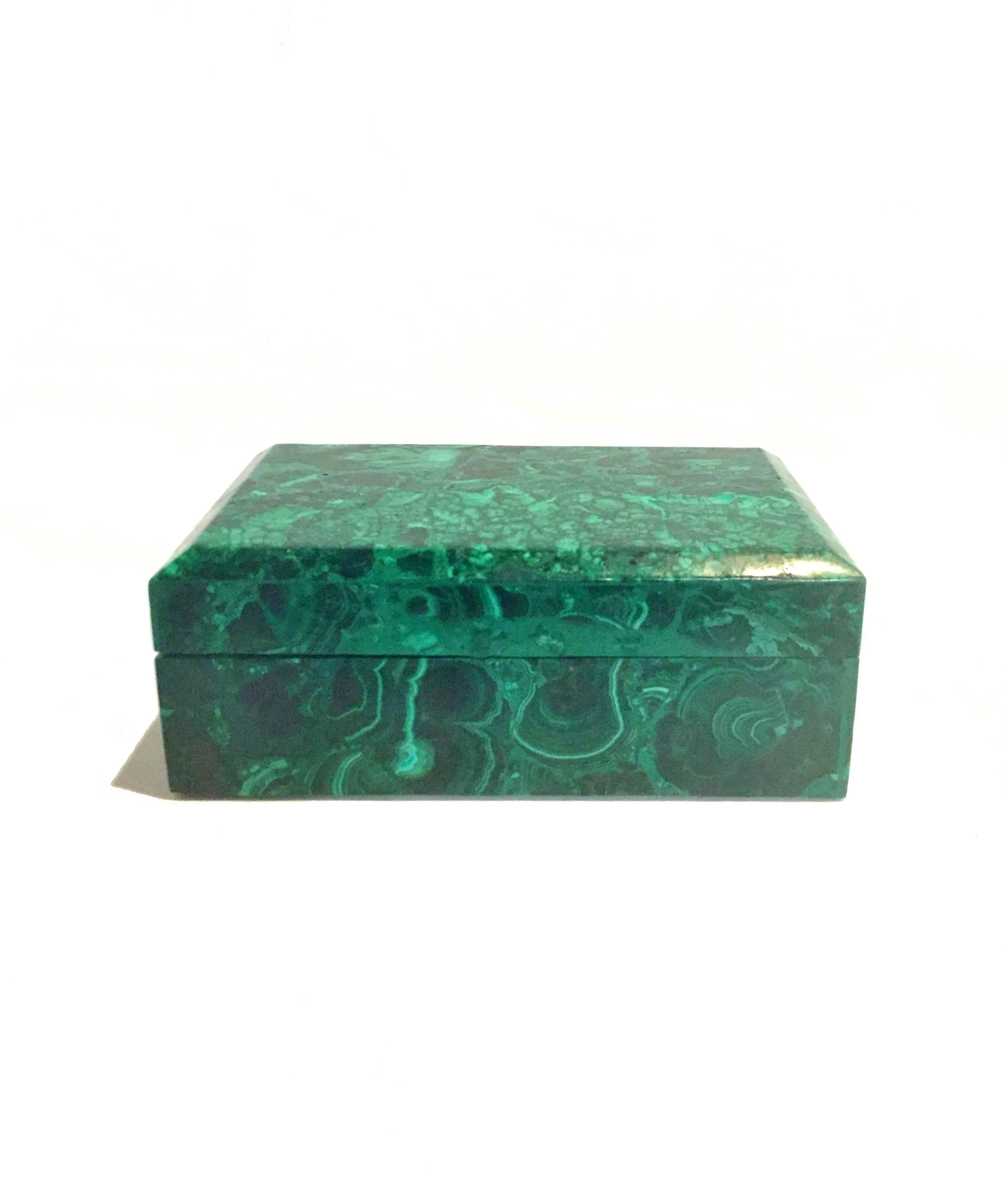 This extraordinary box is made with the most beautiful malachite. All natural with splendid swirls and patterns, this remarkable piece is a sophisticated addition to your desk.

Malachite is a stone of transformation, helping one achieve balance
