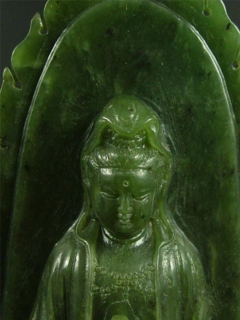 19th century Chinese nephrite green Jade Kwan Yin.

The goddess of compassion, Kwan Yin, is sitting on a double lotus pedestal in meditation position. She is holding a bottle in hands before her chest. The bottle contains willow water, according