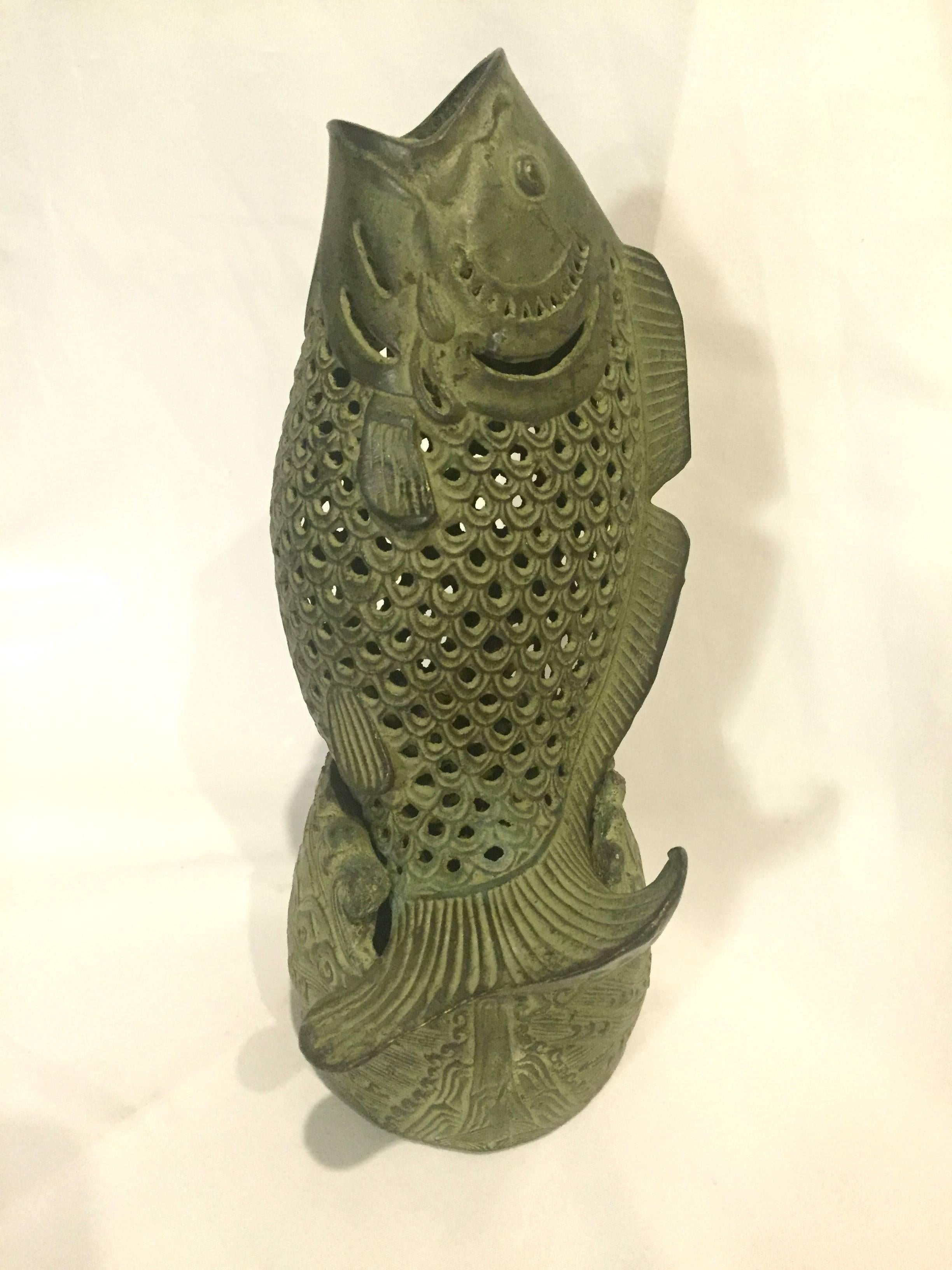Super unique bronze fish incense burner is a delight to have and hold. The fish is the famed and prized oriental carp, which is symbol of prosperity and wealth. The base features waves and water pattern, which echos the 