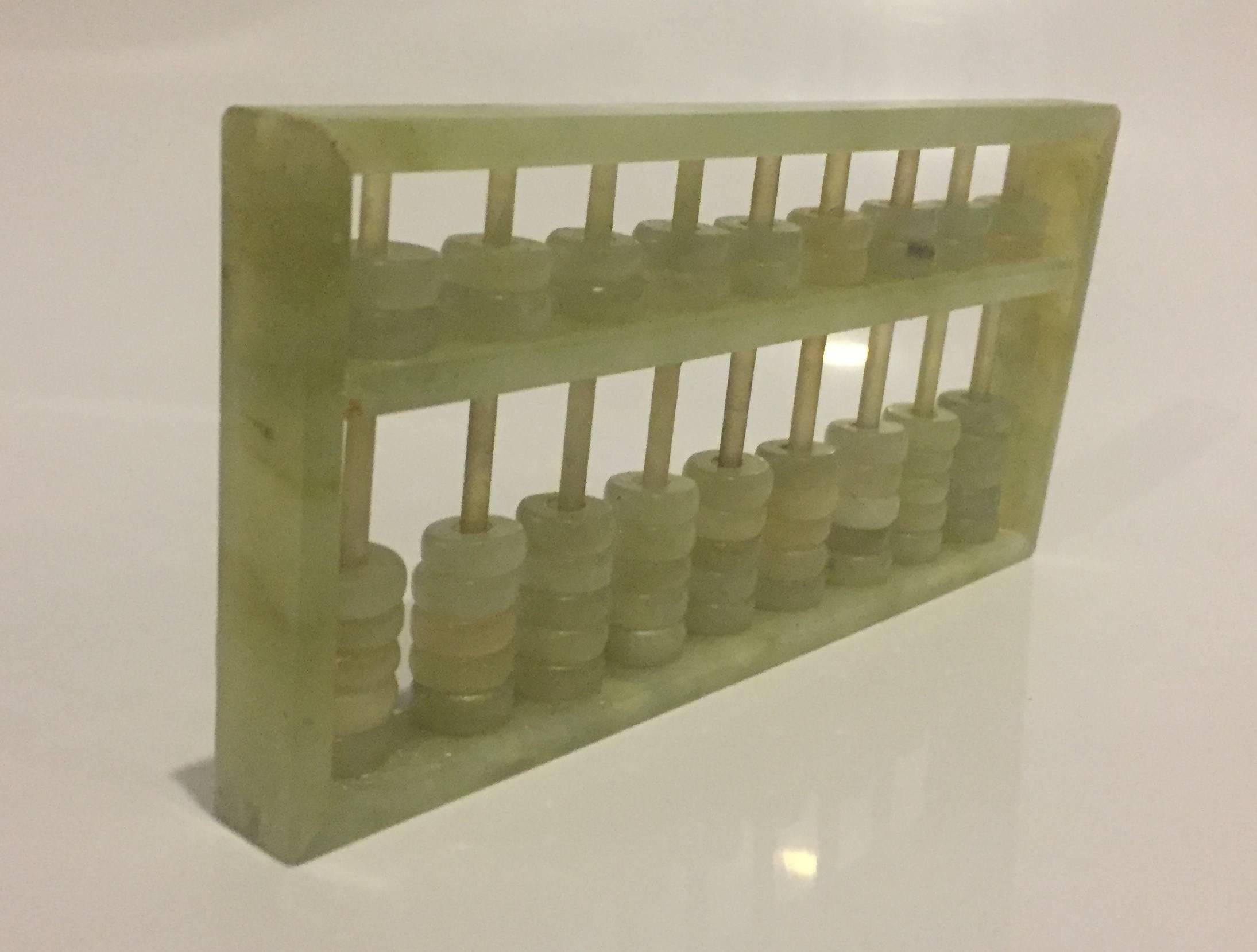 Beautiful Chinese abacus is made with white and green jade. In comparison to most jade abacus that has wood or bamboo bars, this exquisite piece is made completely with jade. The abacus is an amazing calculator that is still used in modern days. Its