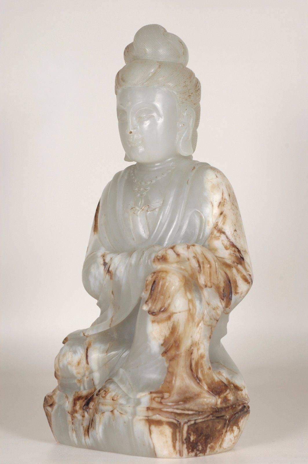 Absolutely beautiful jade Kwan Yin. The jade is of the He Tian Region, the finest in the world.

The statue is carved from an entire block of jade, employing an artistic method which preserves partial original exterior layer of the fine stone.