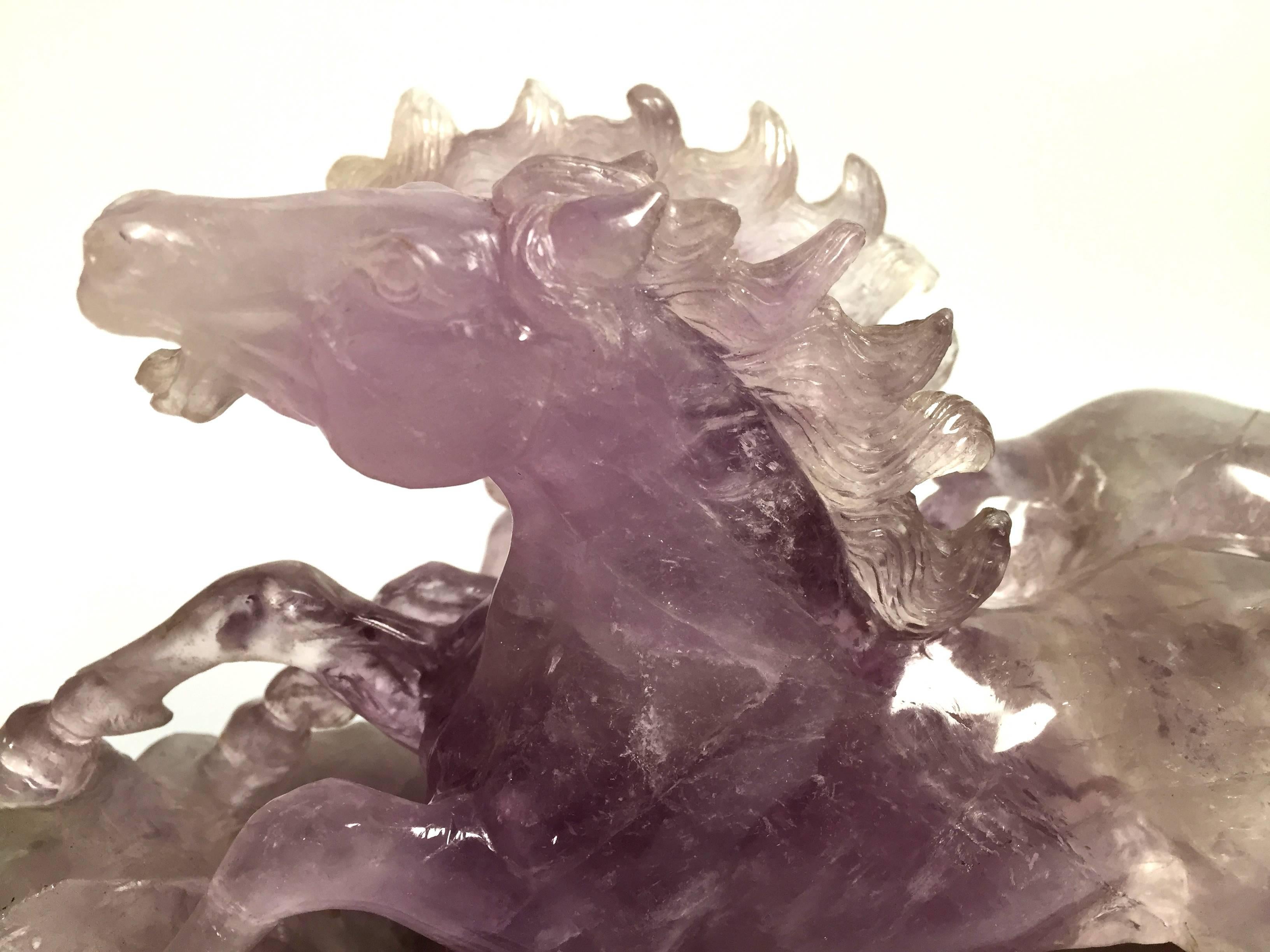 Stunning sculpture hand-carved in all natural pure amethyst. The movements of the horses and expressions are vivid. The mane, legs and muscles, as well as other facial features are exquisite. The amethyst, a semi-precious stone, use on this piece is