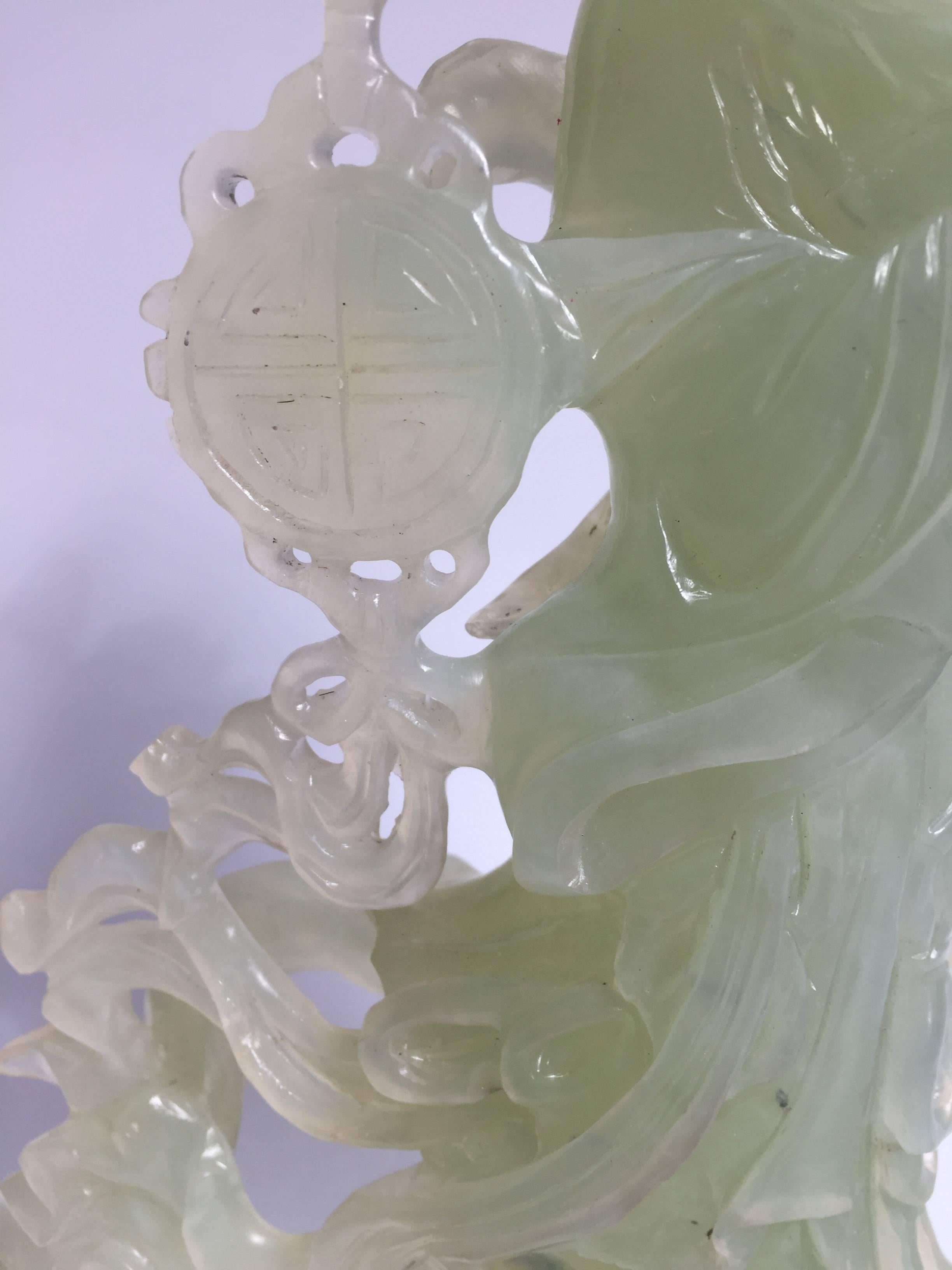 Absolutely beautiful statue of the Chinese moon fairy.

The statue is made of natural green Chinese Xiu Yu, which in China is regarded as jade. It is hand-carved by a master. Her facial features and fingers are finely done. Her robe and ribbons