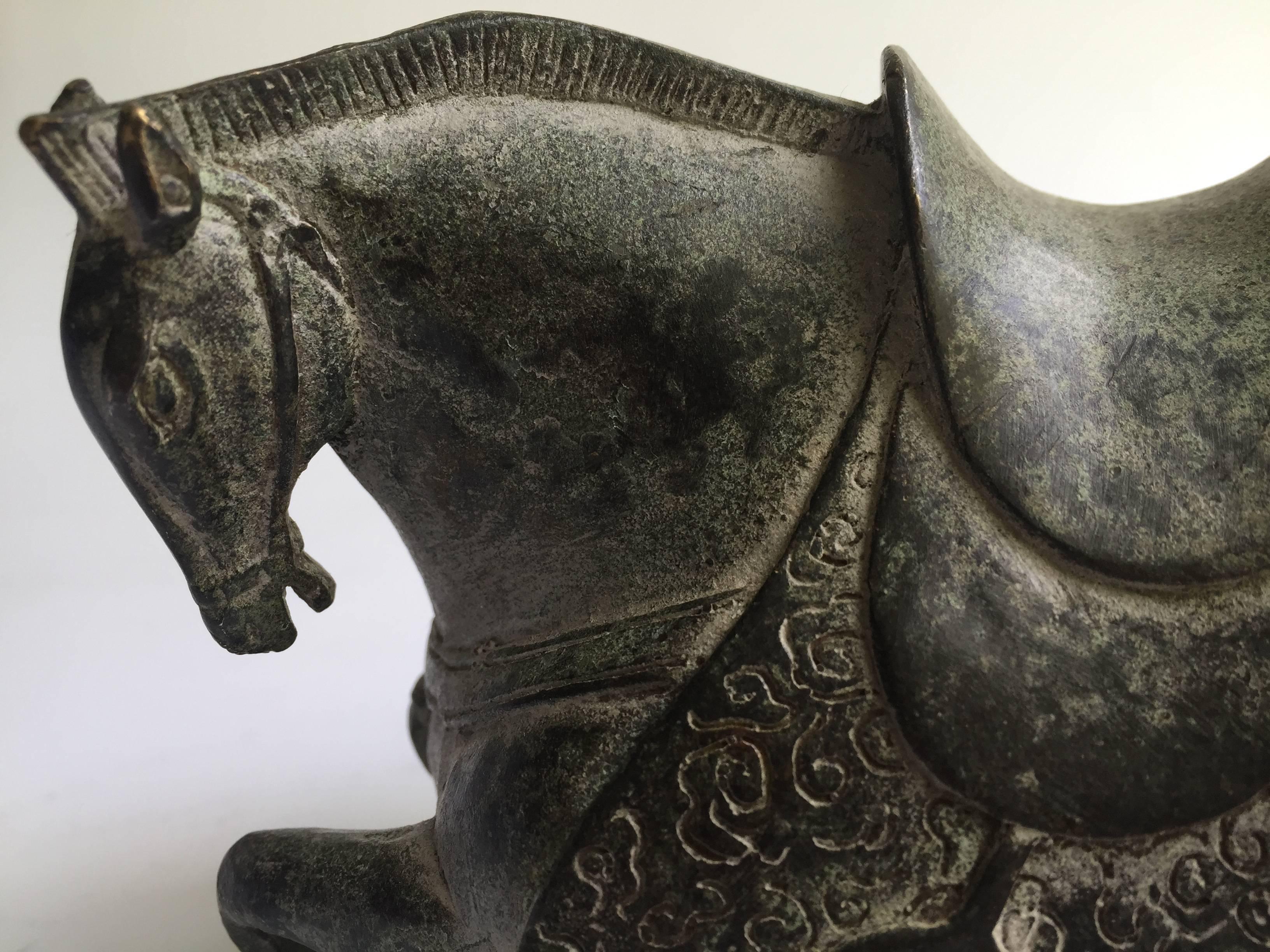 Exquisite 19th century bronze horse in the Han style. The craftsmanship is super with outstanding artistic expression. The scale of the horse's body parts follows an ancient model that has an almost modern feel to it. The muscles are well defined