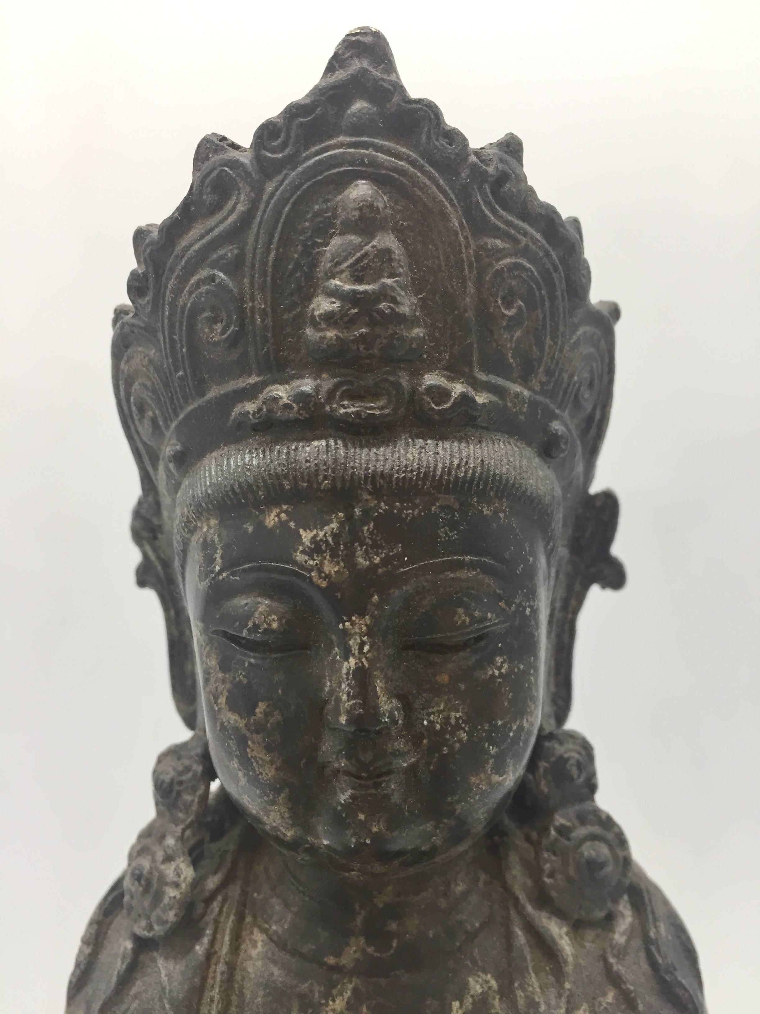 Exquisite 19th century bronze piece features Buddha in the motion of giving blessings. He is seated on the lotus throne, holding a cup of holy water in his hand, ready to bless the people. 

The craftsmanship on this piece is extremely fine. The